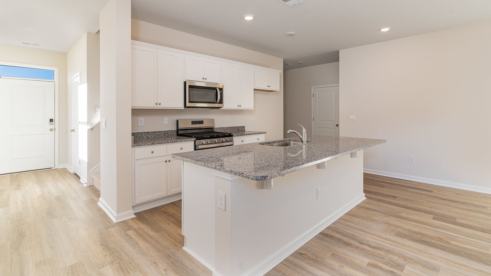 The kitchen features beautiful cabinets, granite countertops, and stainless steel appliances, which are sure to both turn heads and make meal prep easy. You’ll never be too far from the action with the living and dining area right there.