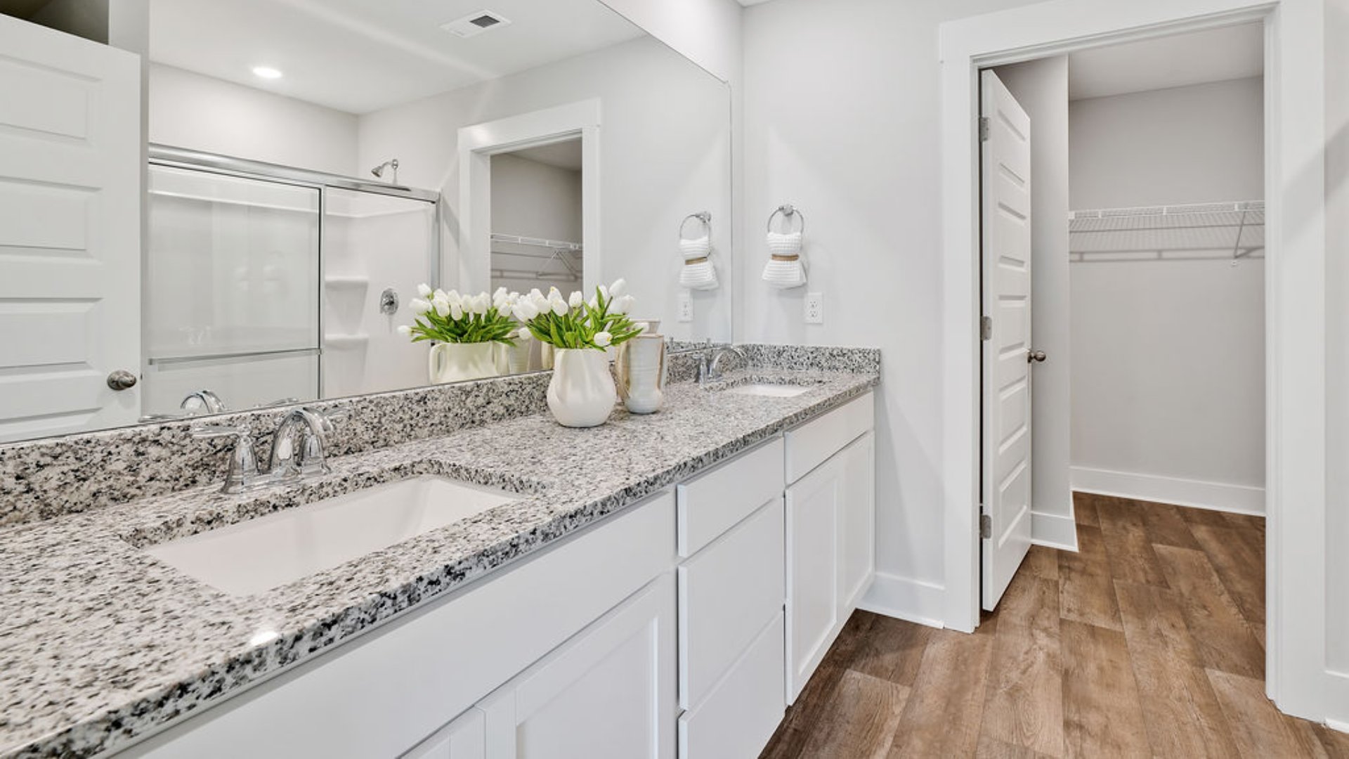The primary bedroom is on the first floor and has its own attached bathroom that features a walk-in closet and all the space you need to get ready in the morning. Sharing a sink isn’t a worry with the double vanity, and you also get additional privacy with a separate door for the toilet and shower.