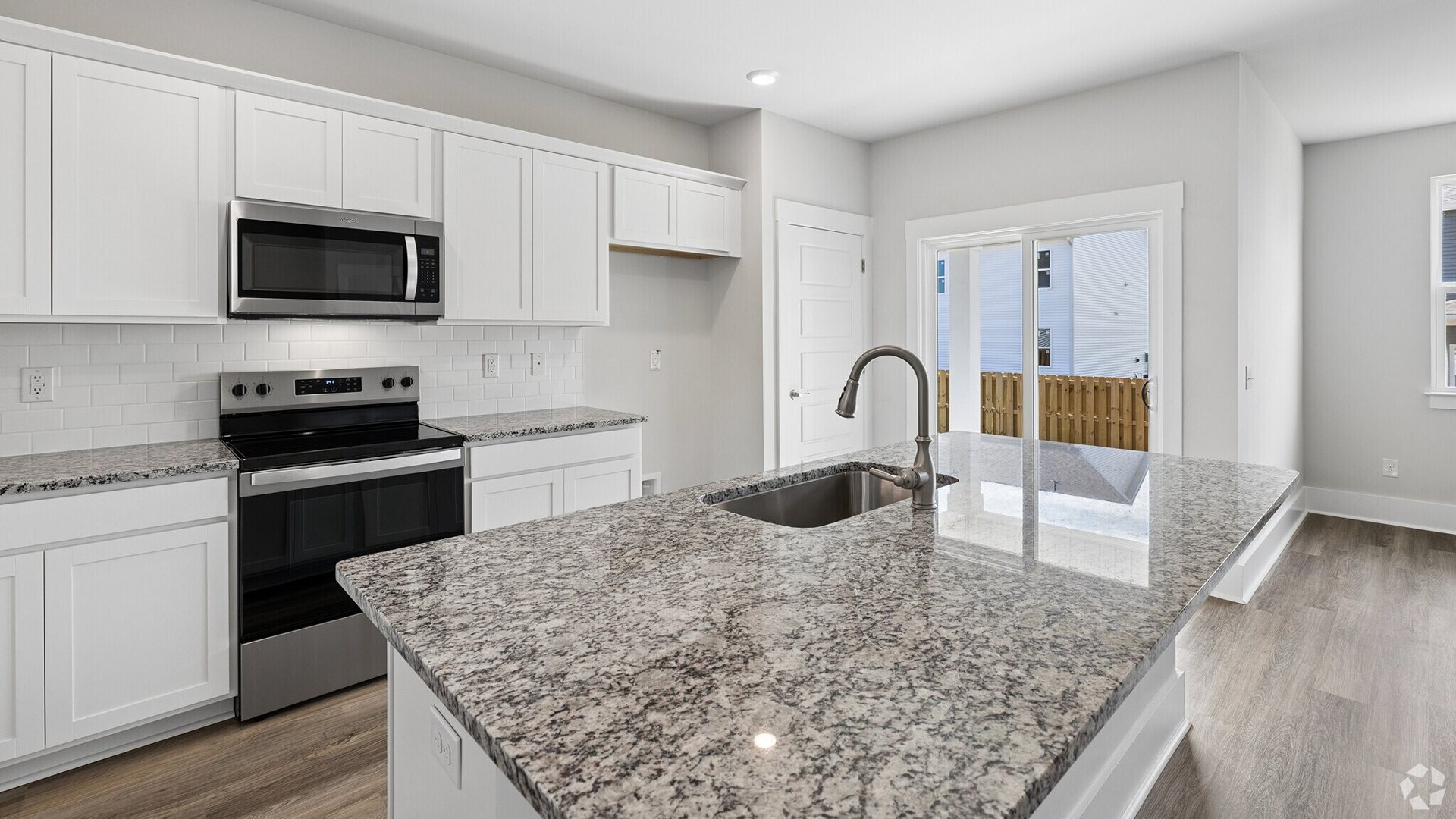 The kitchen features beautiful cabinets, granite countertops, and stainless-steel appliances, which are sure to both turn heads and make meal prep easy