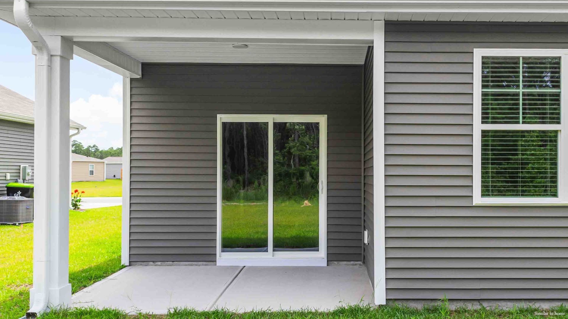 4 panel glass sliding doors open onto large covered porch a perfect spot to start the day or end the evening.