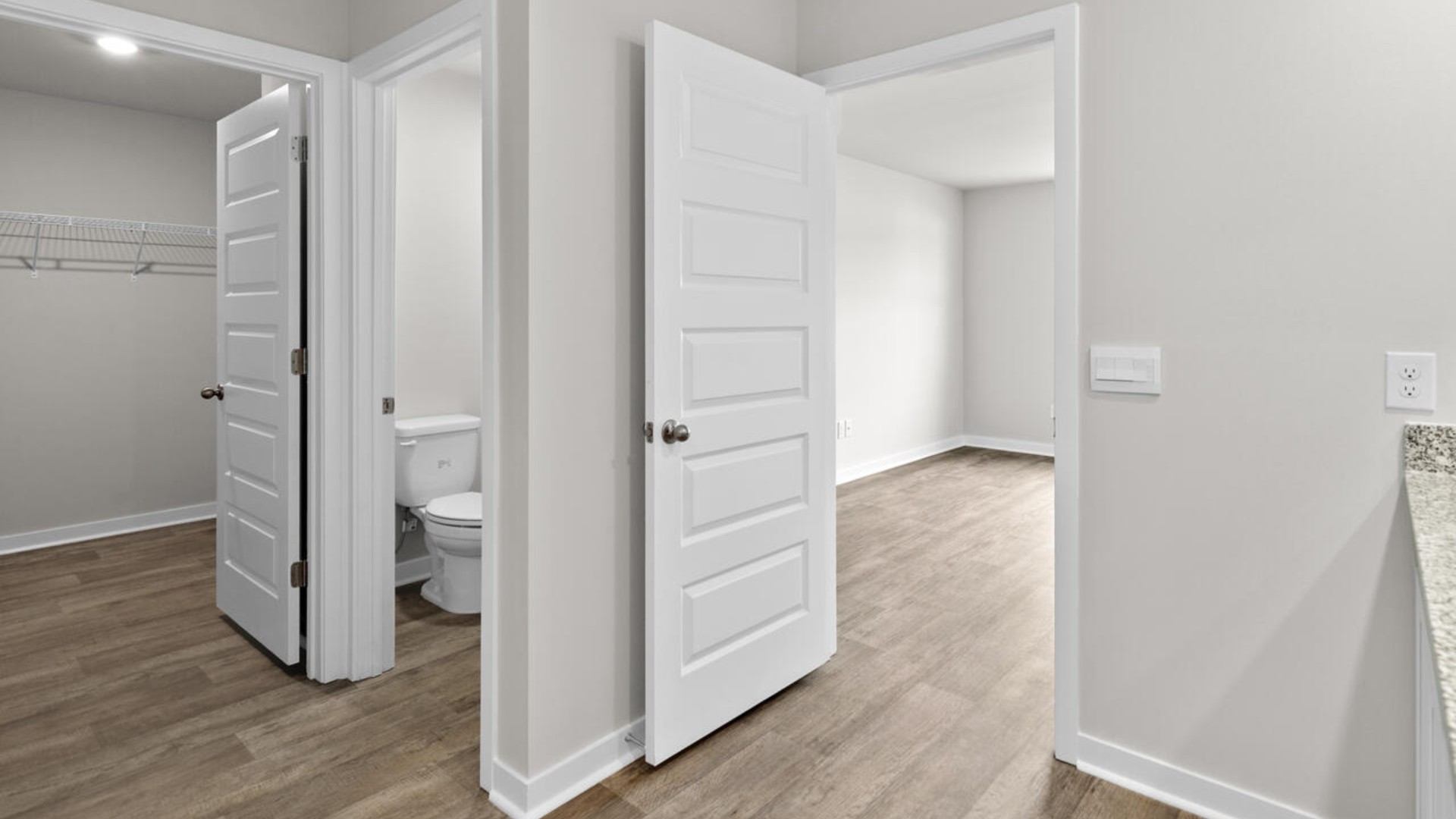 he primary suite is tucked away in the back of the home, offering a peaceful retreat complete with a walk-in shower (glass door included!), granite vanity, and a roomy walk-in closet.