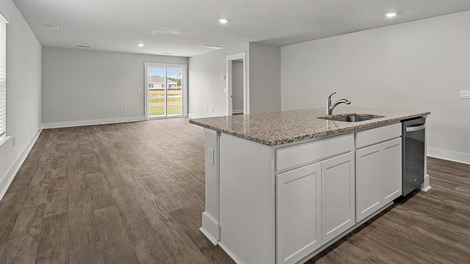 The kitchen features beautiful cabinets, granite countertops, and stainless steel appliances, which are sure to both turn heads and make meal prep easy. You’ll never be too far from the action with the living and dining area right there.