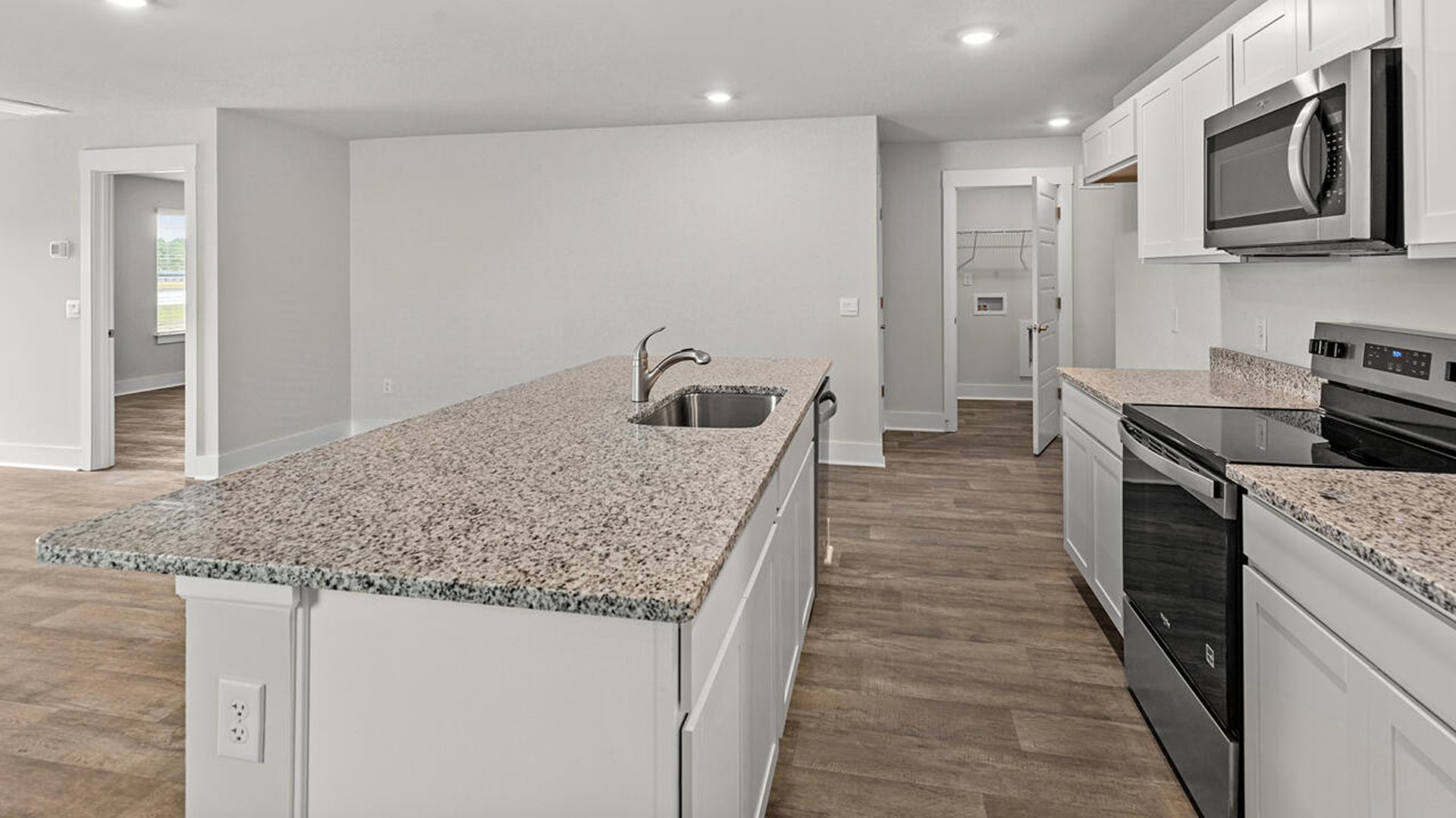 The kitchen features beautiful cabinets, granite countertops, and stainless steel appliances, which are sure to both turn heads and make meal prep easy. You’ll never be too far from the action with the living and dining area right there.