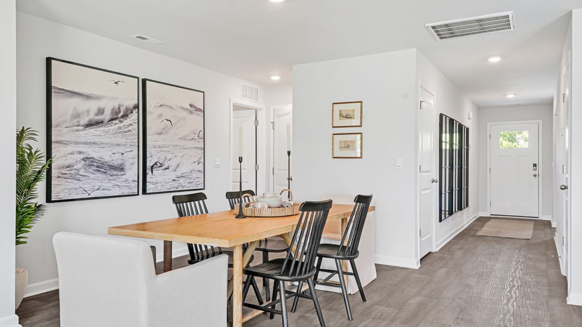 The open-concept family room, kitchen, and dining area feature stainless steel appliances, including a smooth-top range, dishwasher, and overhead microwave.