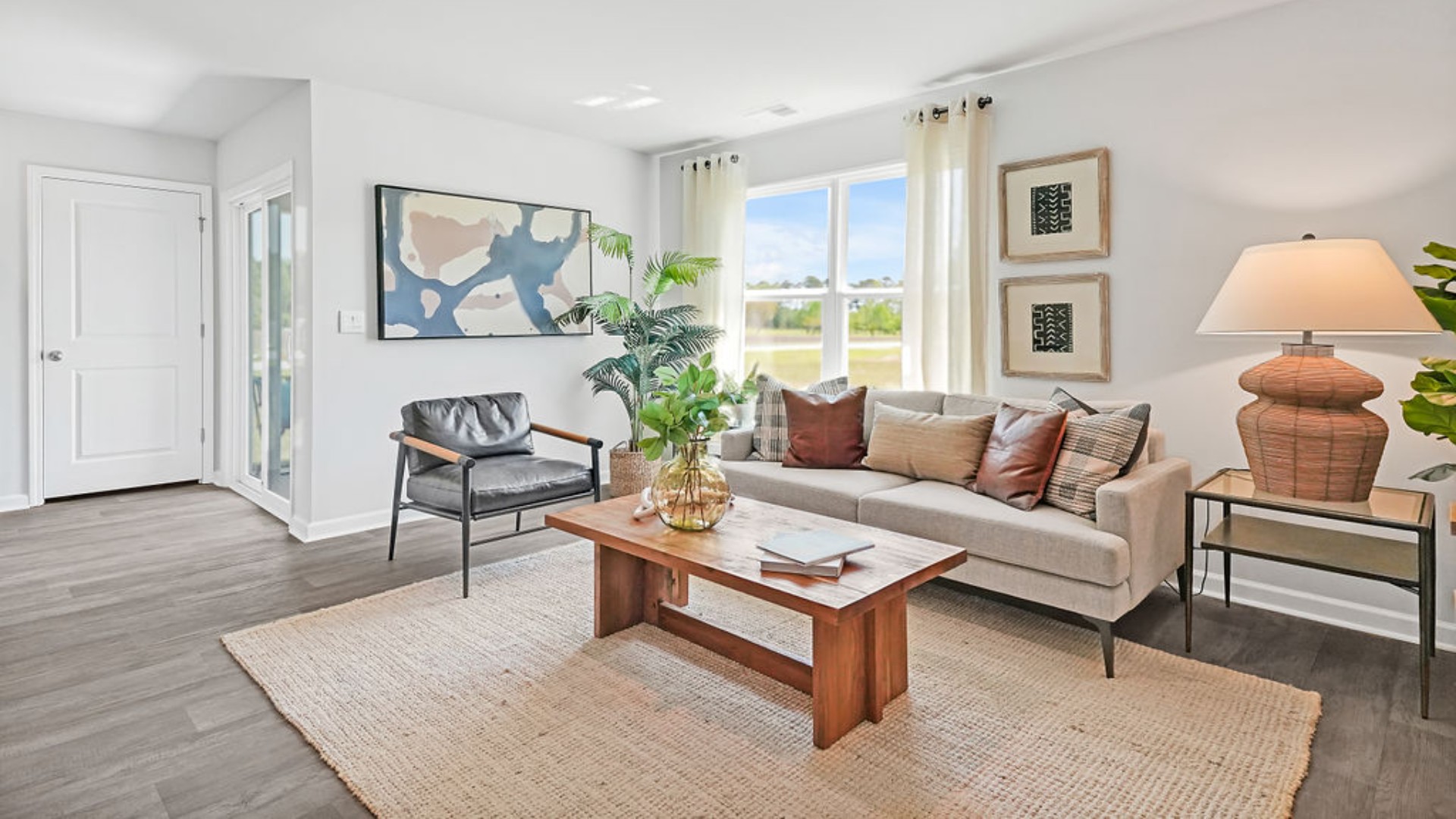 The open-concept family room, kitchen, and dining area feature stainless steel appliances, including a smooth-top range, dishwasher, and overhead microwave.