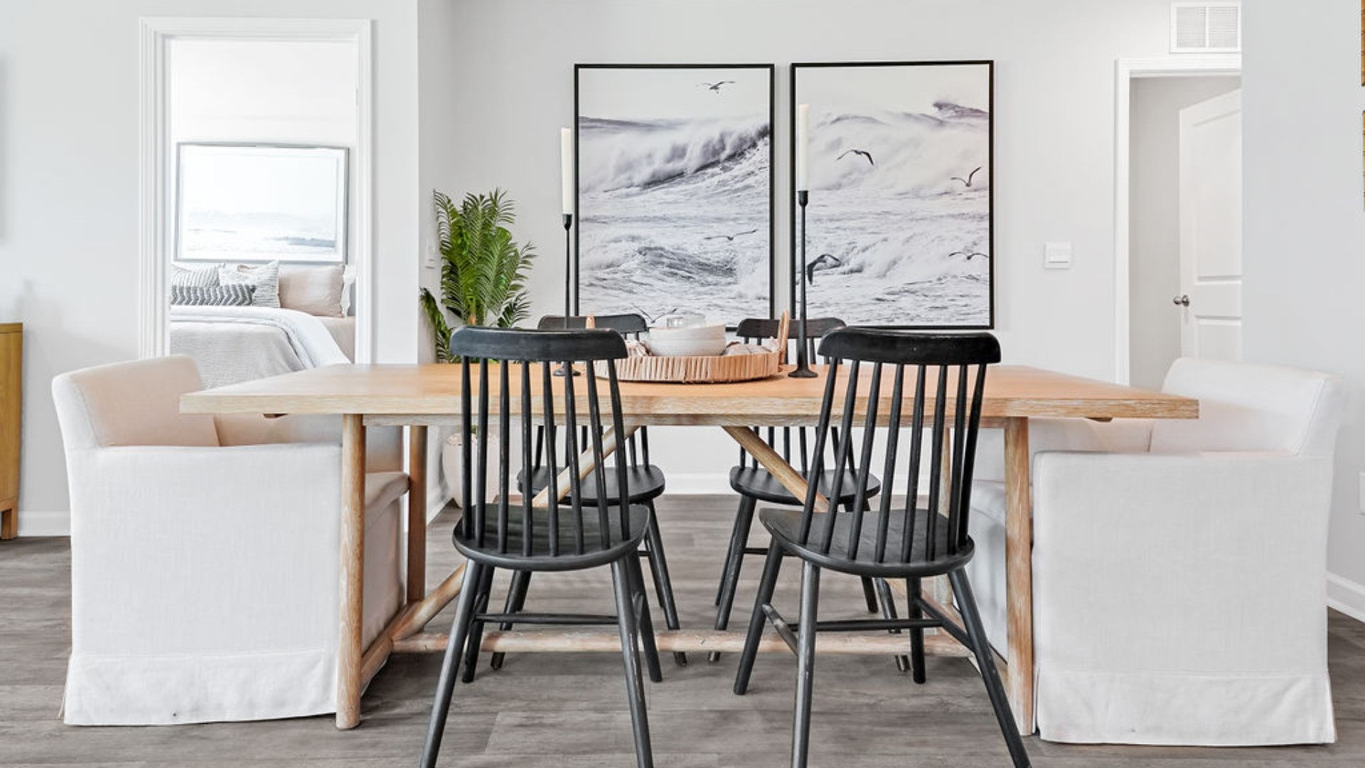 The open-concept family room, kitchen, and dining area feature stainless steel appliances, including a smooth-top range, dishwasher, and overhead microwave.