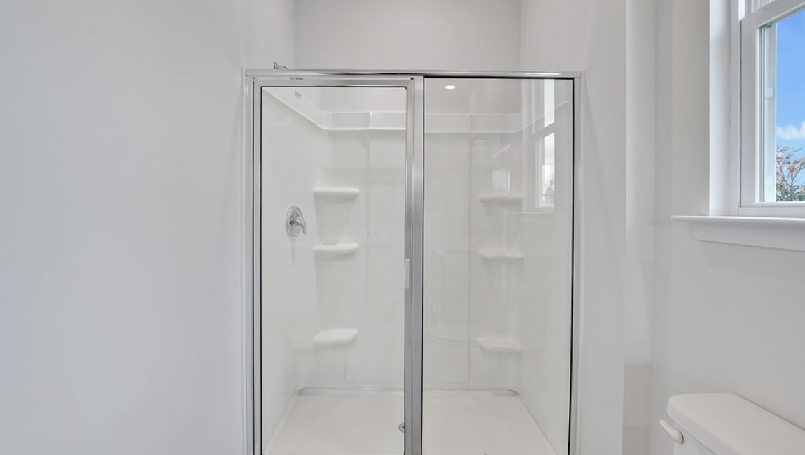 At the back, the Primary Suite provides privacy with a large walk-in closet and walk-in shower. In every bedroom you’ll have vinyl flooring and a closet in each room