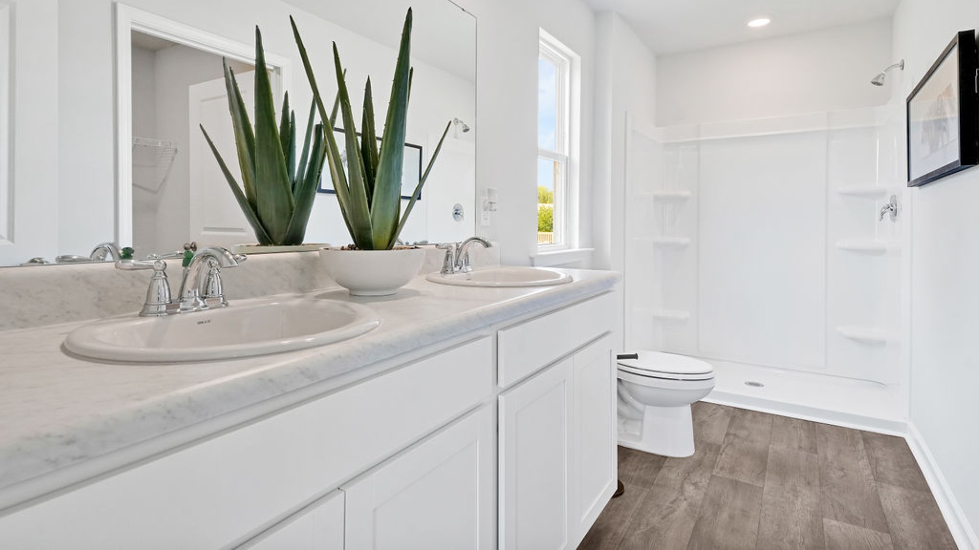 t the back, the Primary Suite provides privacy with a large walk-in closet and walk-in shower. In every bedroom you’ll have vinyl flooring and a closet in each room.