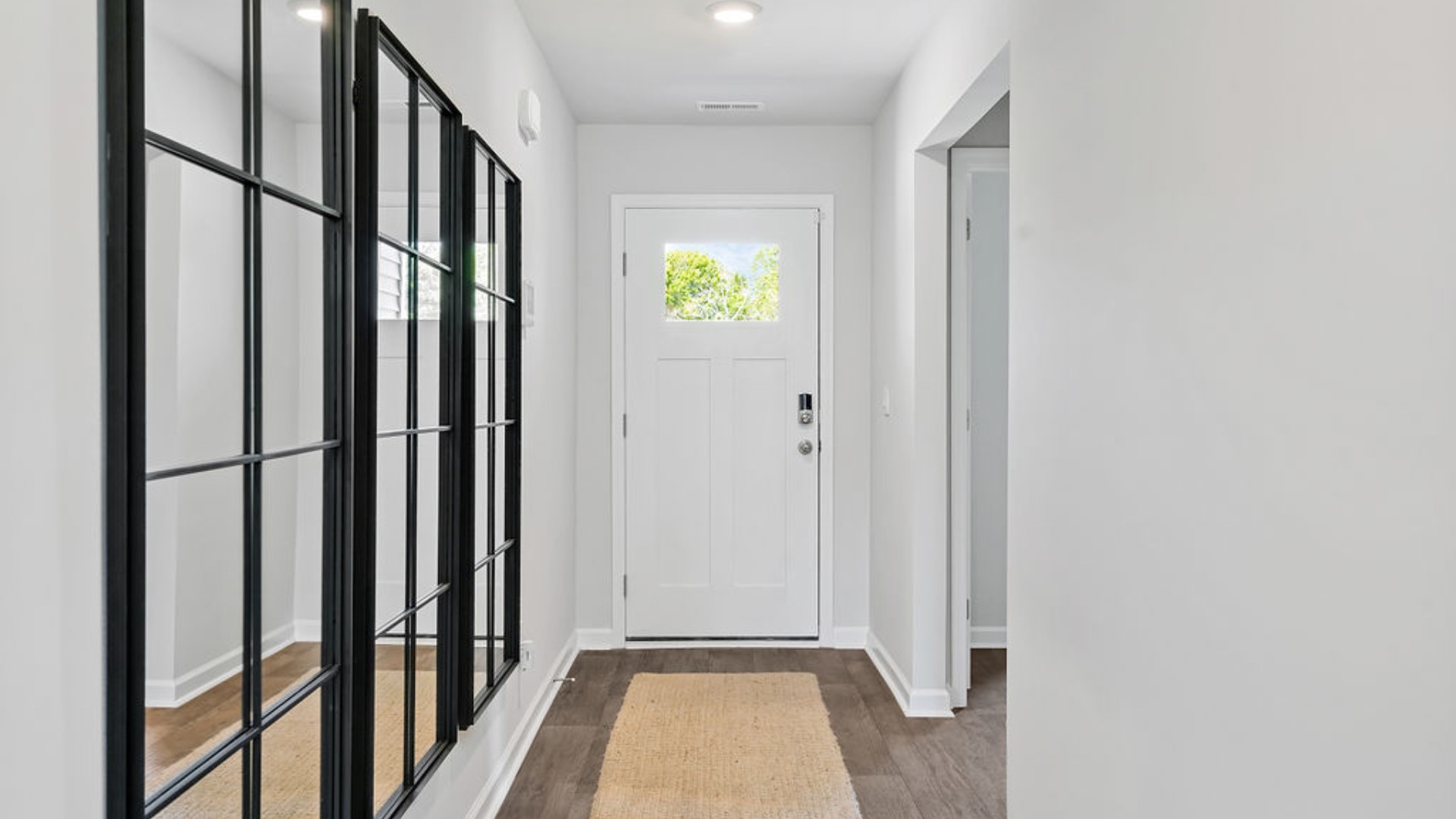 At the front are two guest bedrooms and a full bathroom, perfect for visitors or a home office. T