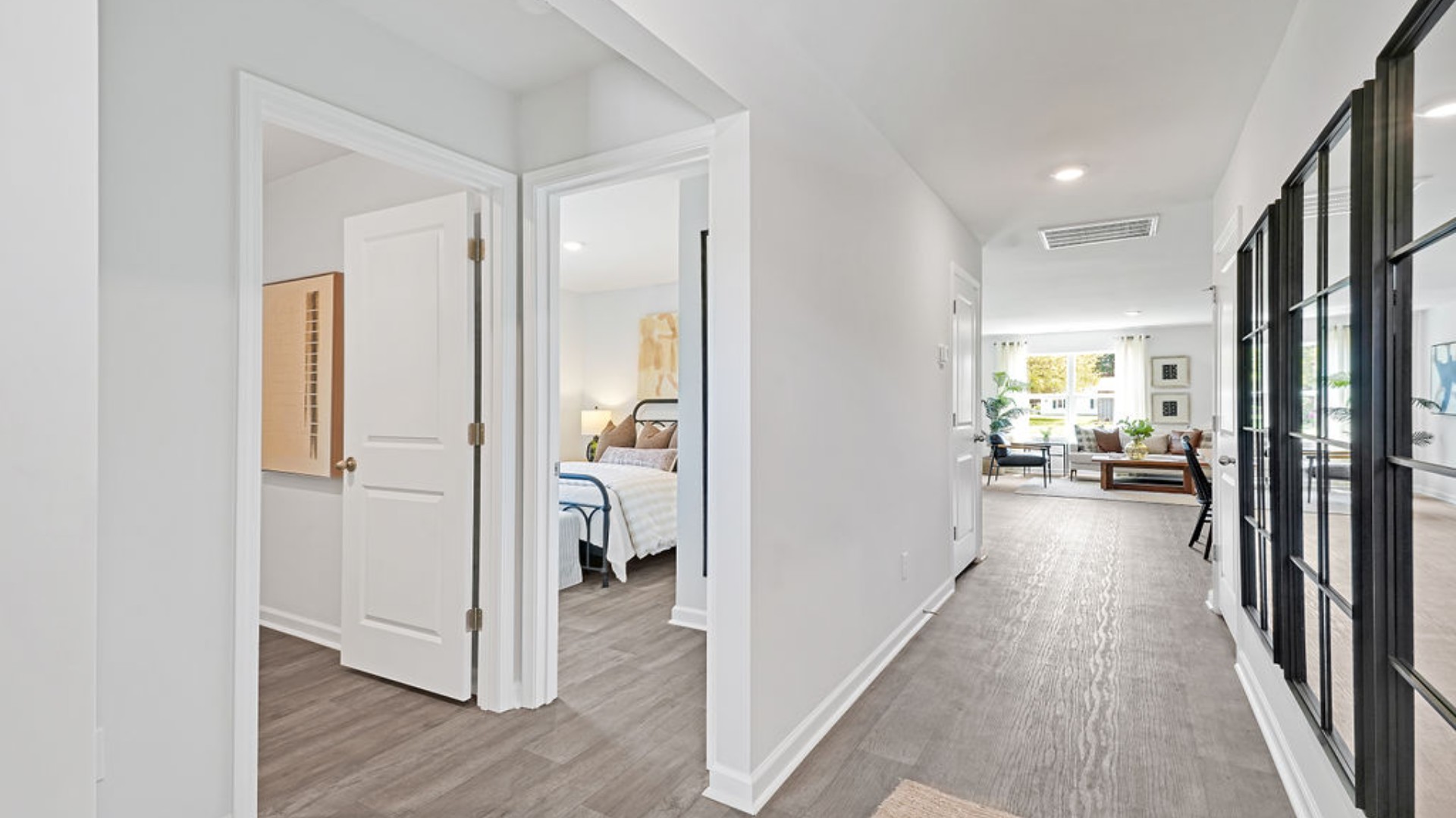 At the front are two guest bedrooms and a full bathroom, perfect for visitors or a home office. T