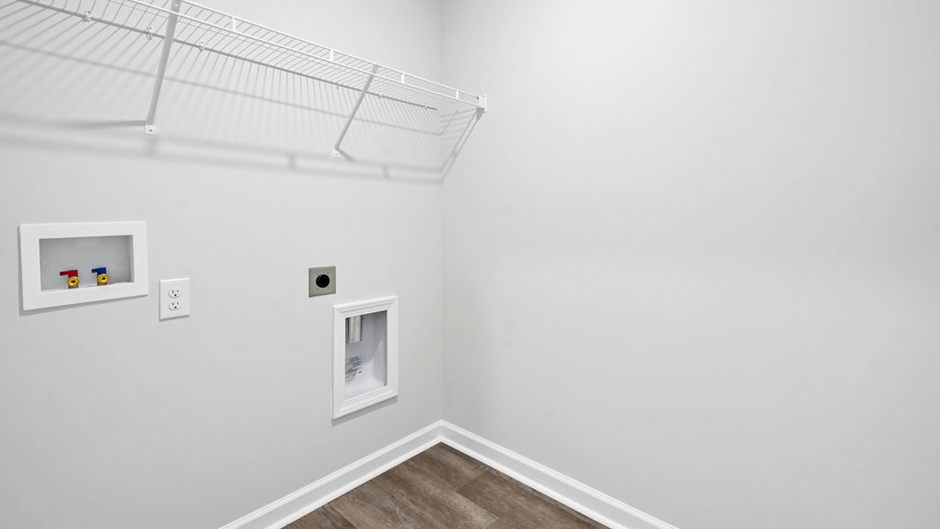 The open-concept family room, kitchen, and dining area feature stainless steel appliances, including a smooth-top range, dishwasher, and overhead microwave