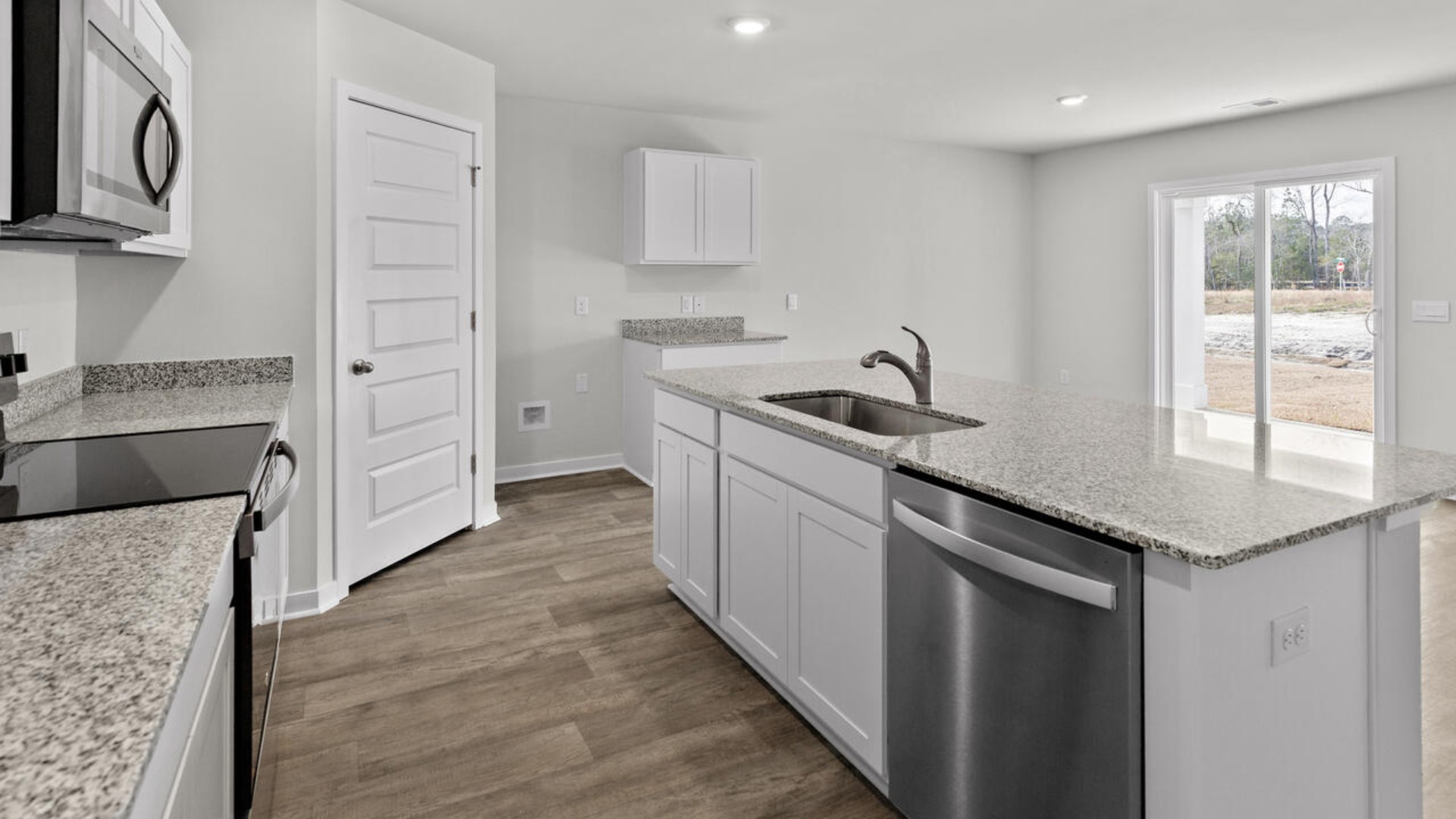 The kitchen features a large island, laminate countertops, and stainless steel appliances, which are sure to both turn heads and make meal prep easy. You’ll never be too far from the action with the living and dining area right there.