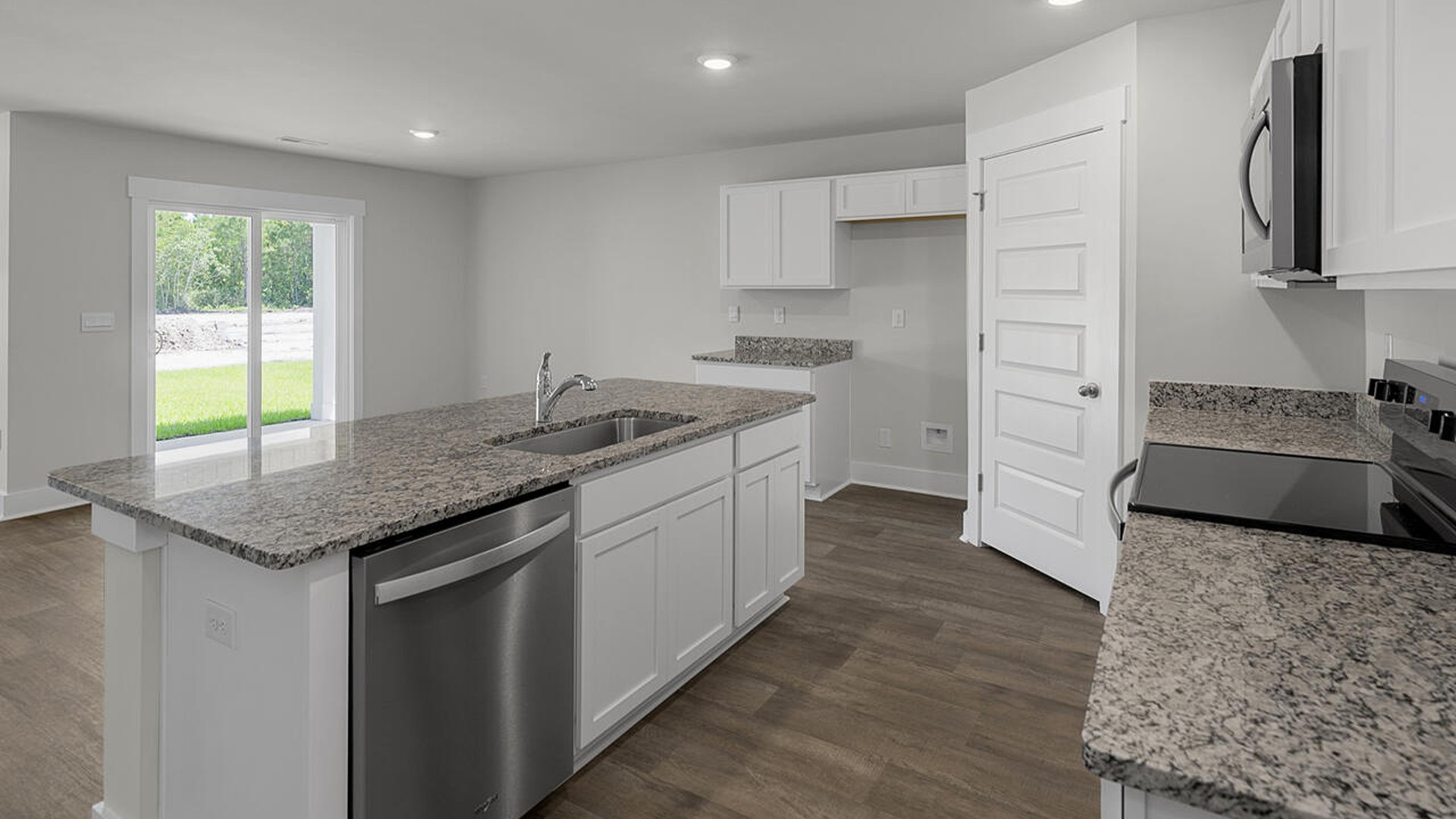 The kitchen features a large island, laminate countertops, and stainless-steel appliances, which are sure to both turn heads and make meal prep easy. You’ll never be too far from the action with the living and dining area right there.