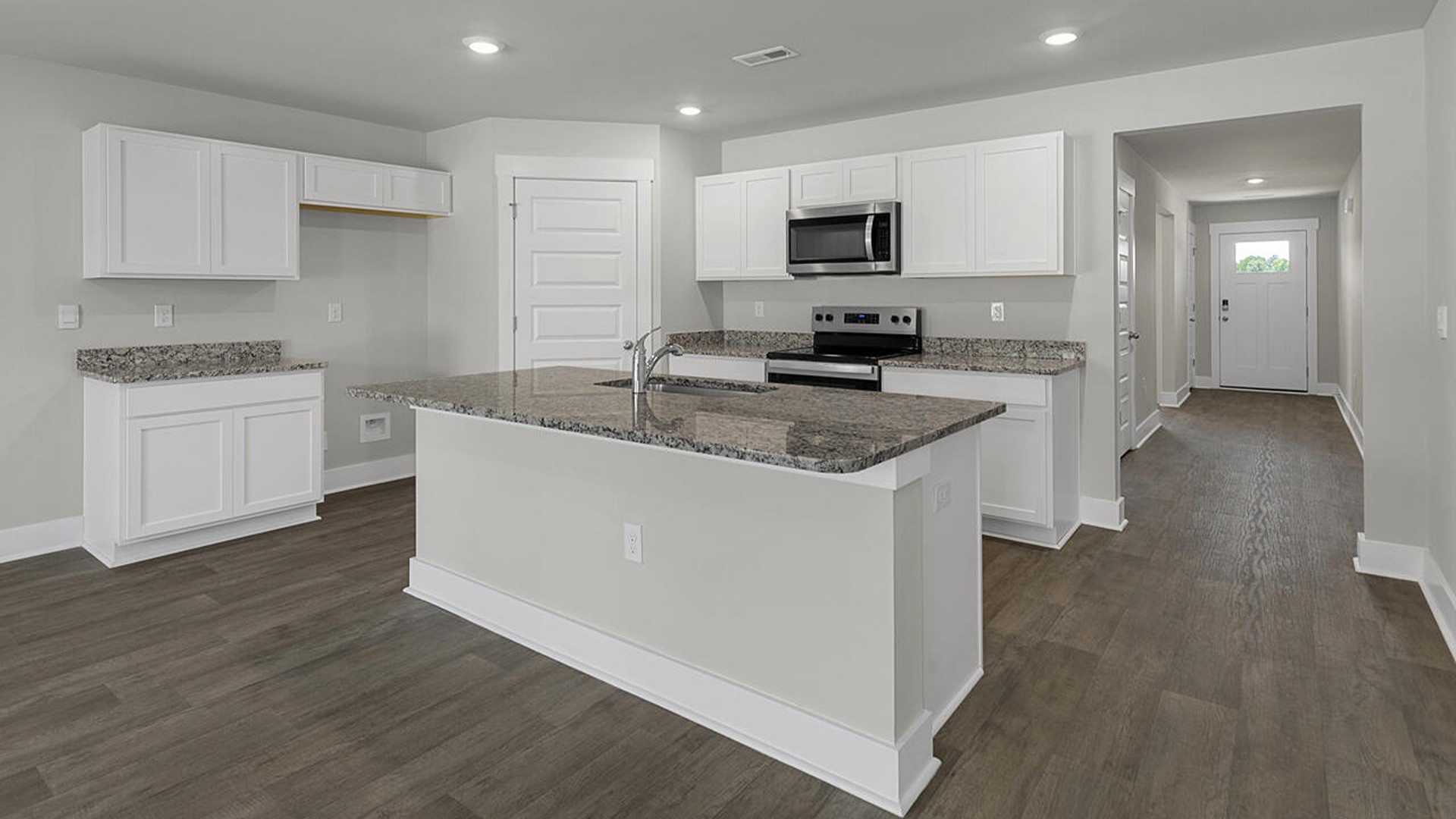 The kitchen features a large island, laminate countertops, and stainless-steel appliances, which are sure to both turn heads and make meal prep easy. You’ll never be too far from the action with the living and dining area right there.