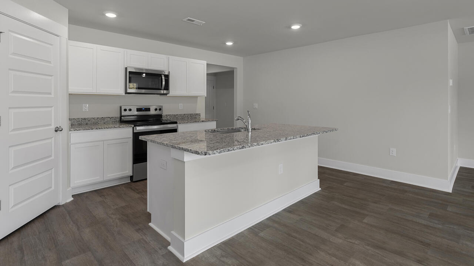 The kitchen features a large island, laminate countertops, and stainless-steel appliances, which are sure to both turn heads and make meal prep easy. You’ll never be too far from the action with the living and dining area right there.