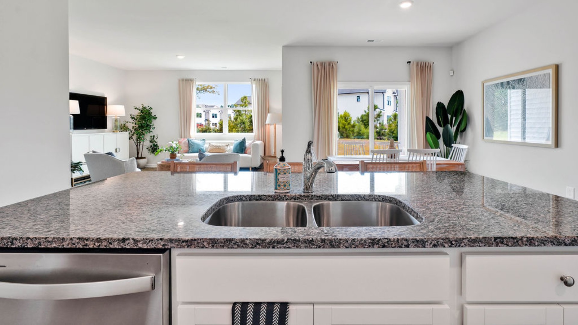 The kitchen features a large island, laminate countertops, and stainless steel appliances, which are sure to both turn heads and make meal prep easy. You’ll never be too far from the action with the living and dining area right there.