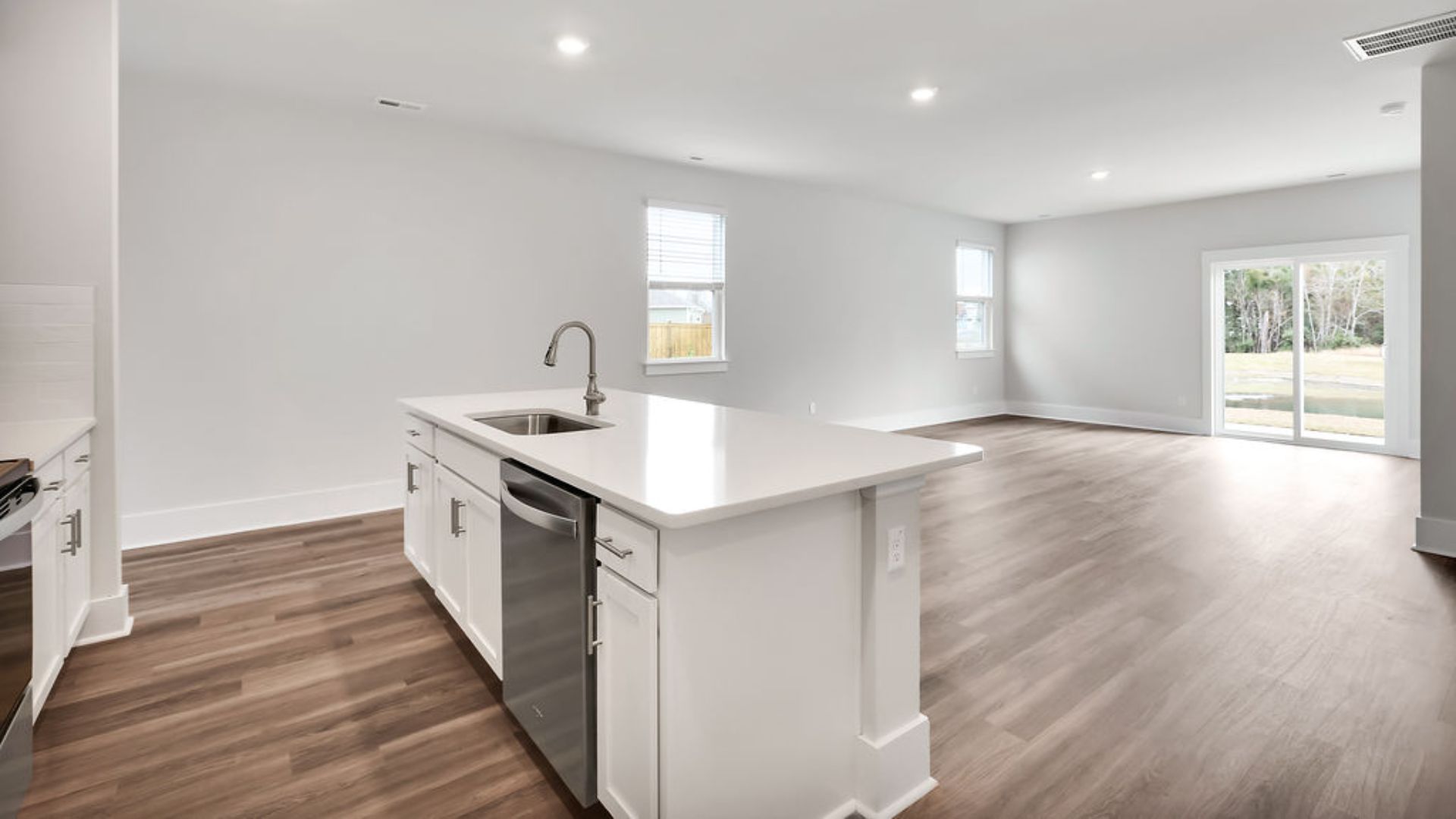 Entering the great room, we find the dining area, family room and a wonderful cook's kitchen are all together for open living. Downstairs, there is a half bath.