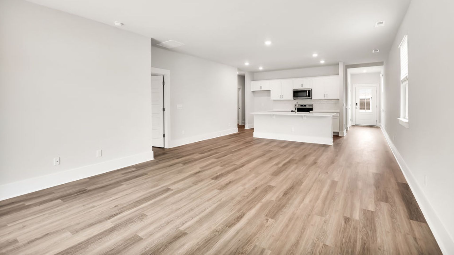 Entering the great room, we find the dining area, family room and a wonderful cook's kitchen are all together for open living. Downstairs, there is a half bath.
