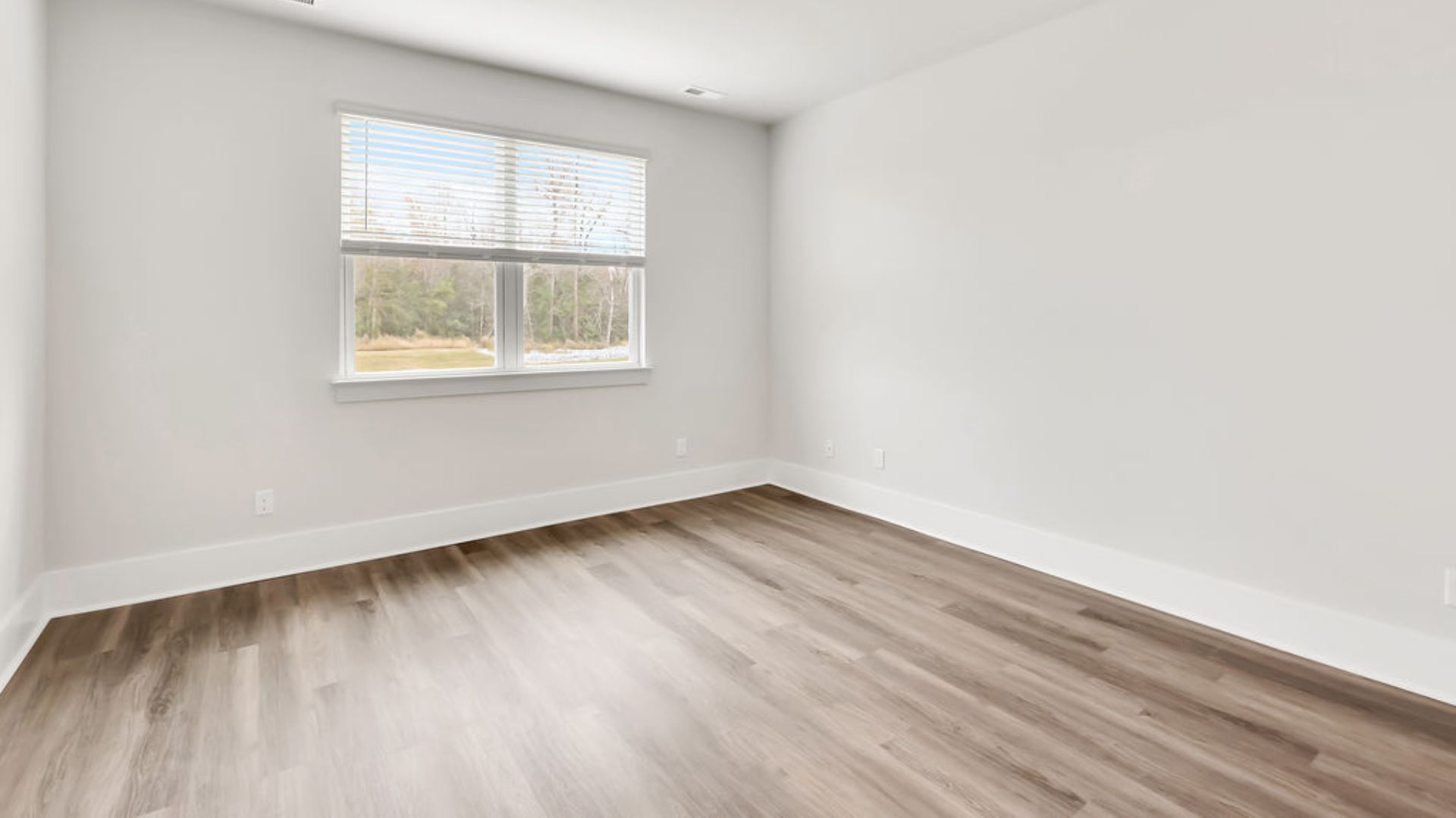 The primary suite on the main level. Entering the great room, we find the dining area, family room and a wonderful cook's kitchen are all together for open living.