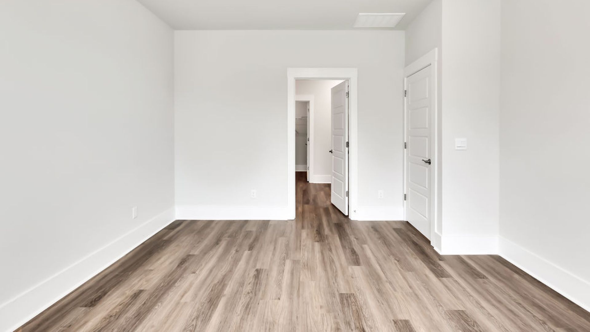 The primary suite on the main level. Entering the great room, we find the dining area, family room and a wonderful cook's kitchen are all together for open living.