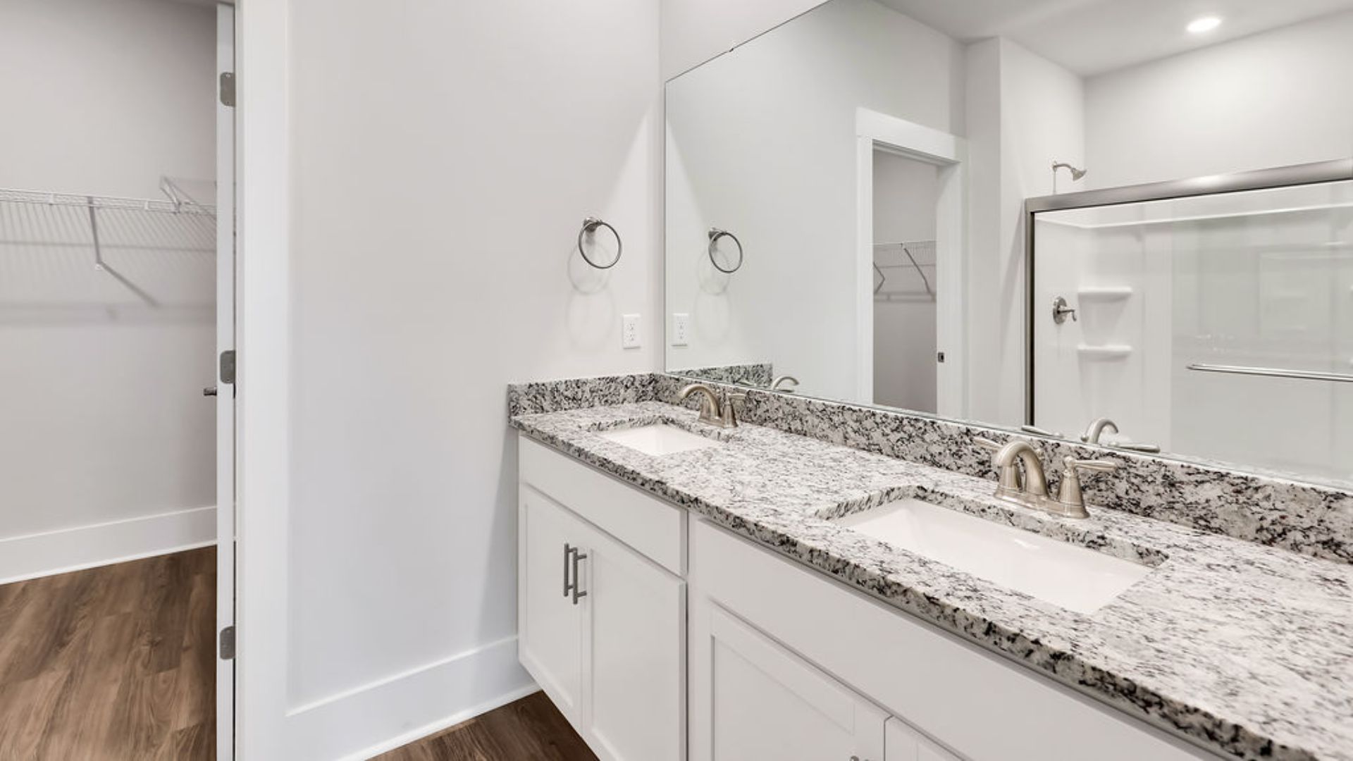 The primary suite on the main level. Entering the great room, we find the dining area, family room and a wonderful cook's kitchen are all together for open living.