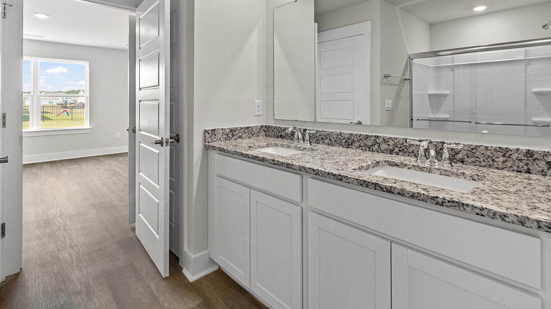 The  primary suite on the main level. Entering the great room we find the dining area, family room and a wonderful cook's kitchen are all together for open living