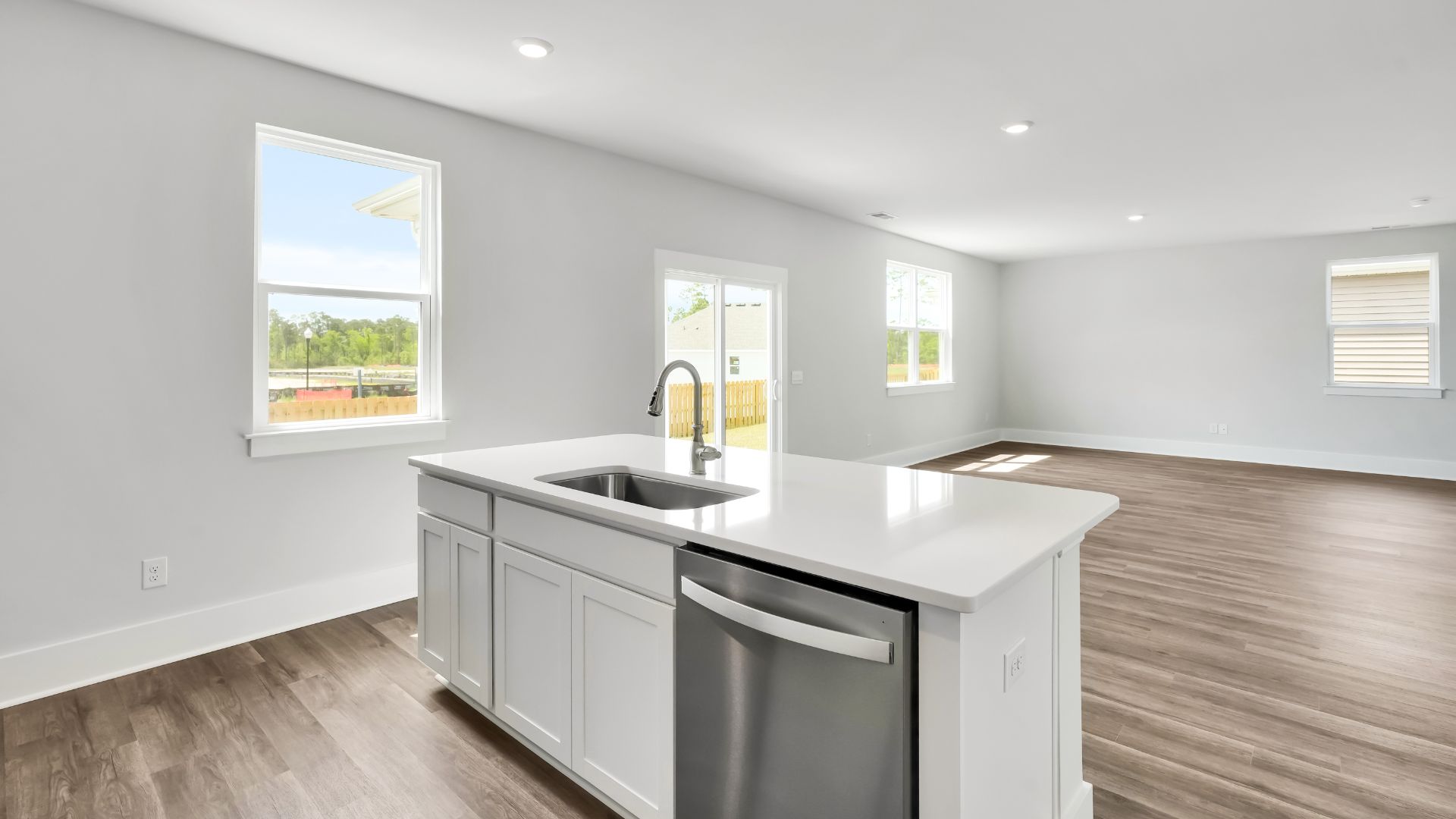 The kitchen features a large island and stainless-steel appliances, which are sure to both turn heads and make meal prep easy. You’ll never be too far from the action with the living and dining area right there.