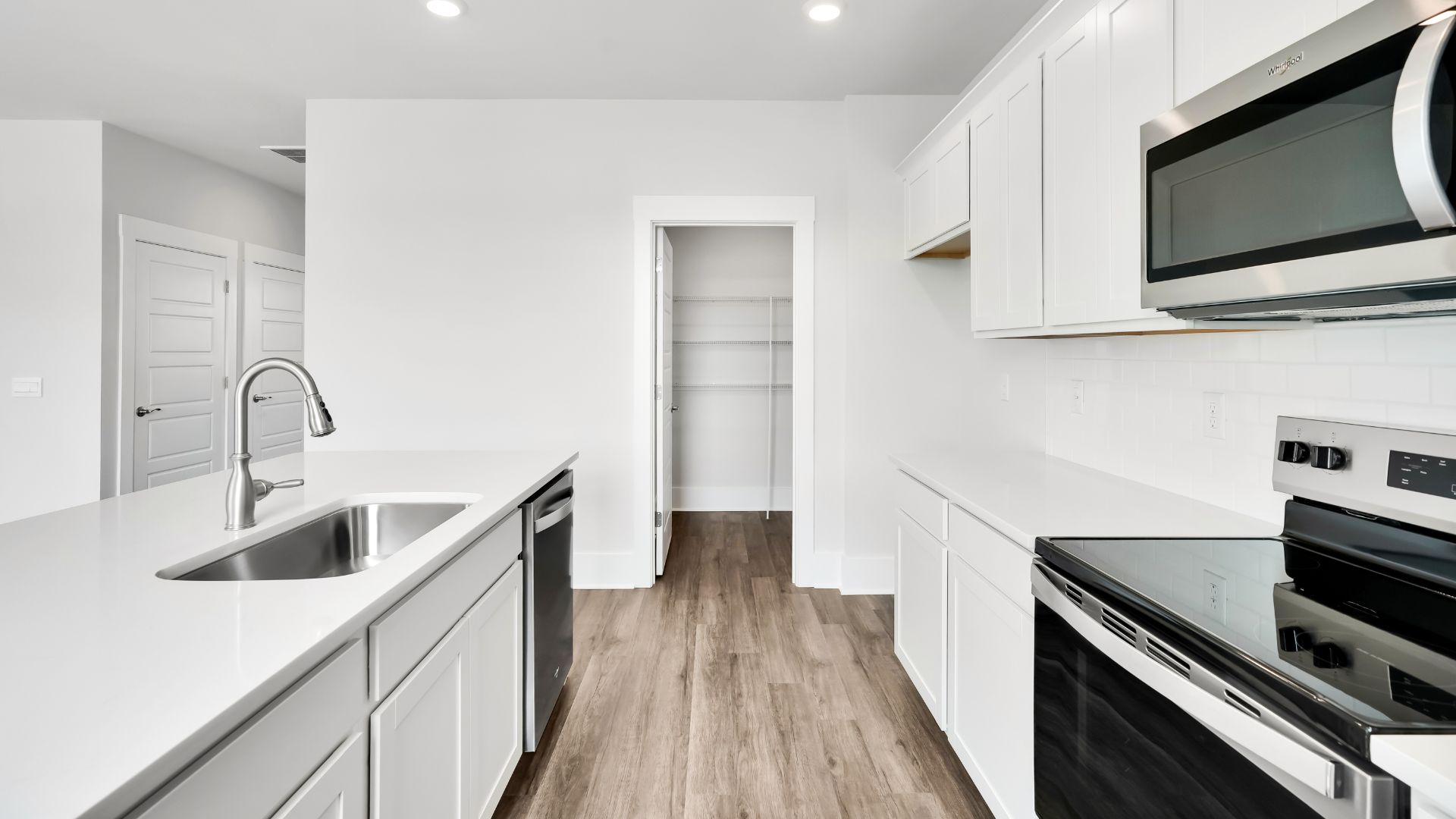 The kitchen features a large island and stainless-steel appliances, which are sure to both turn heads and make meal prep easy. You’ll never be too far from the action with the living and dining area right there.