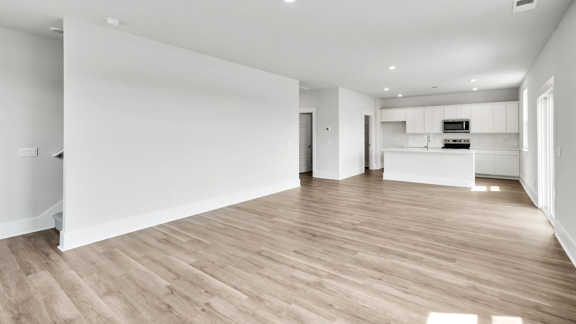 The kitchen features a large island and stainless-steel appliances, which are sure to both turn heads and make meal prep easy. You’ll never be too far from the action with the living and dining area right there.