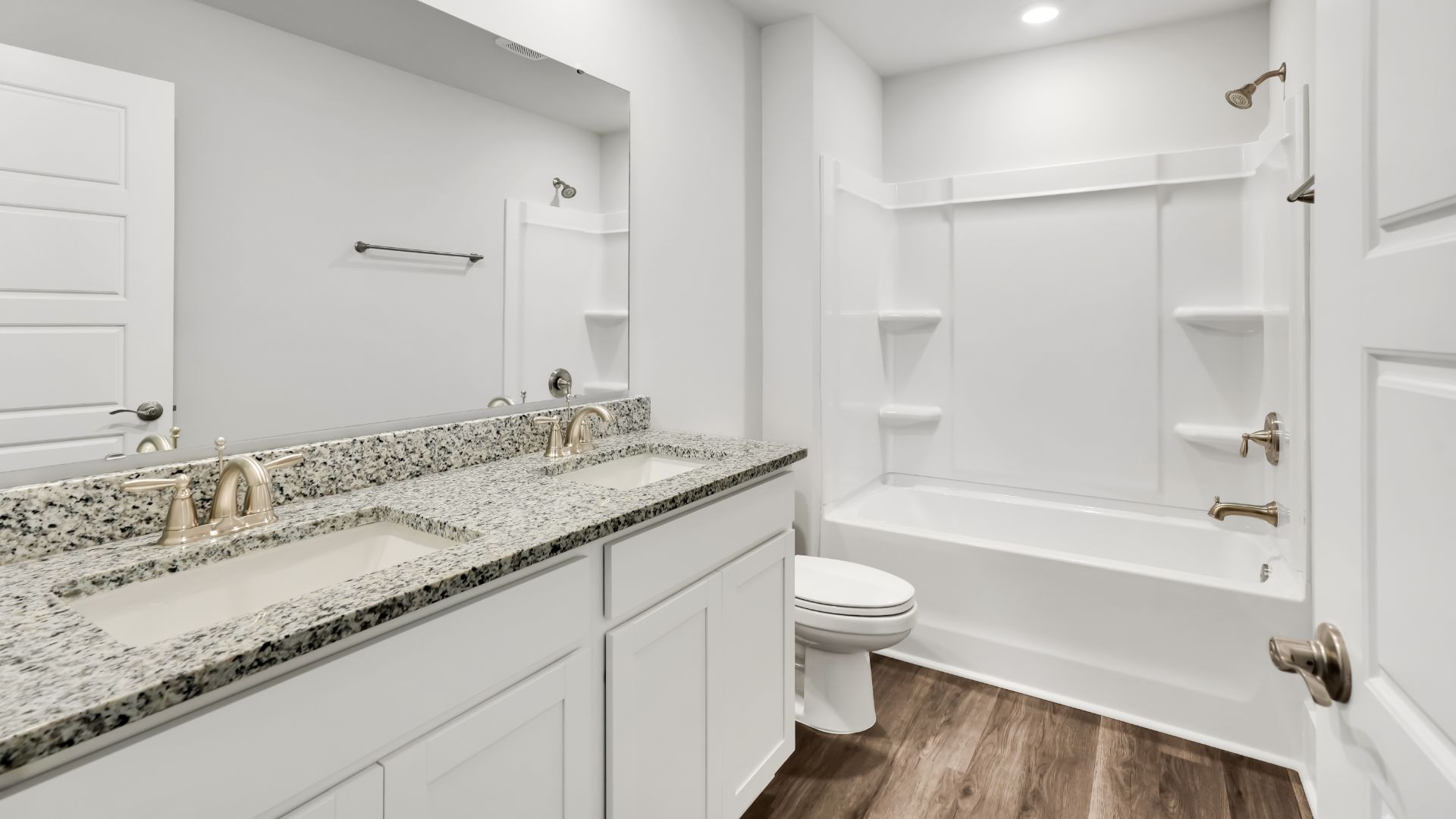 Upstairs, the Primary Suite offers a private bathroom, and the rest of the second floor includes three additional bedrooms and a convenient laundry room.
