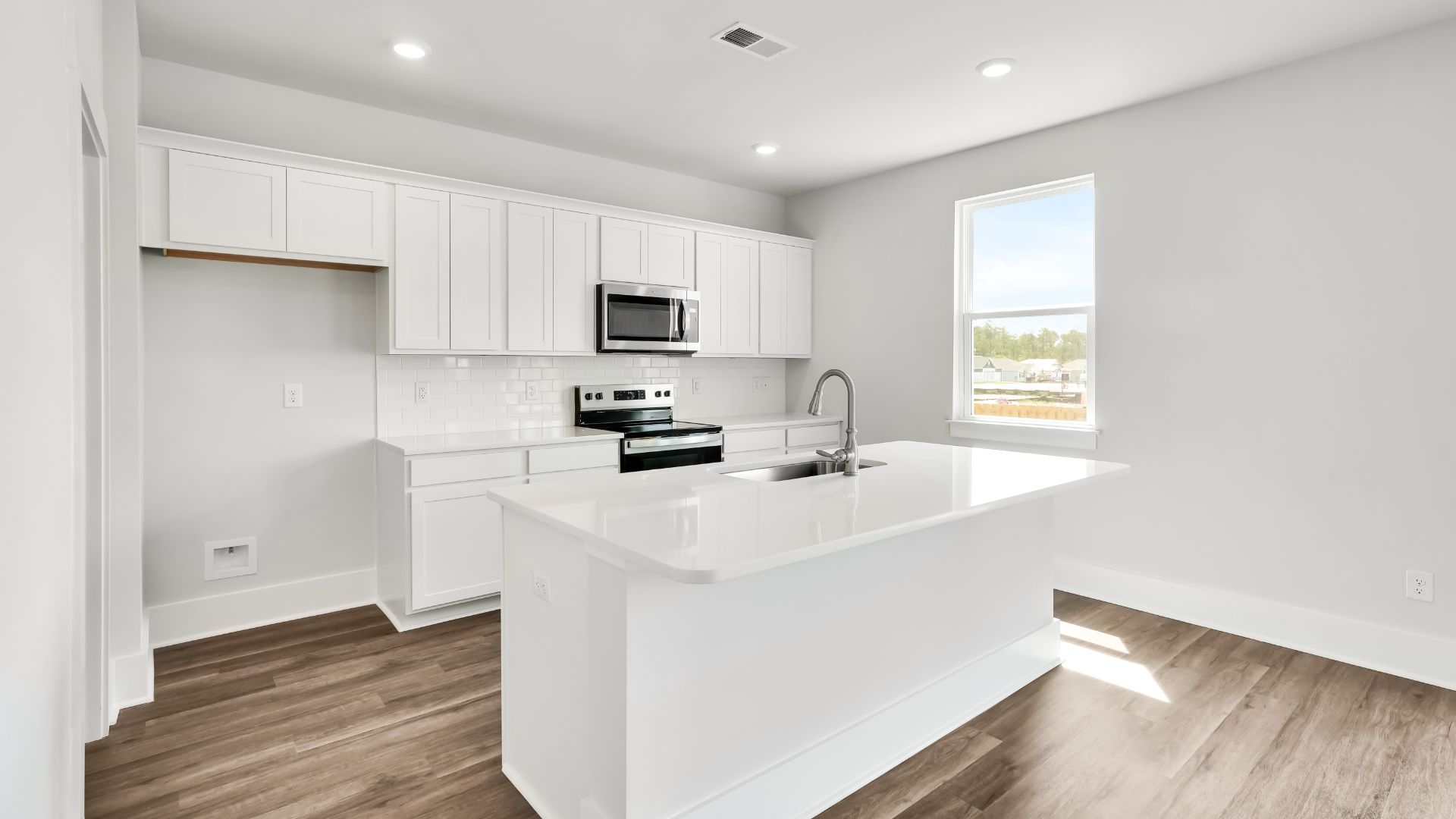 The kitchen features a large island and stainless-steel appliances, which are sure to both turn heads and make meal prep easy. You’ll never be too far from the action with the living and dining area right there.