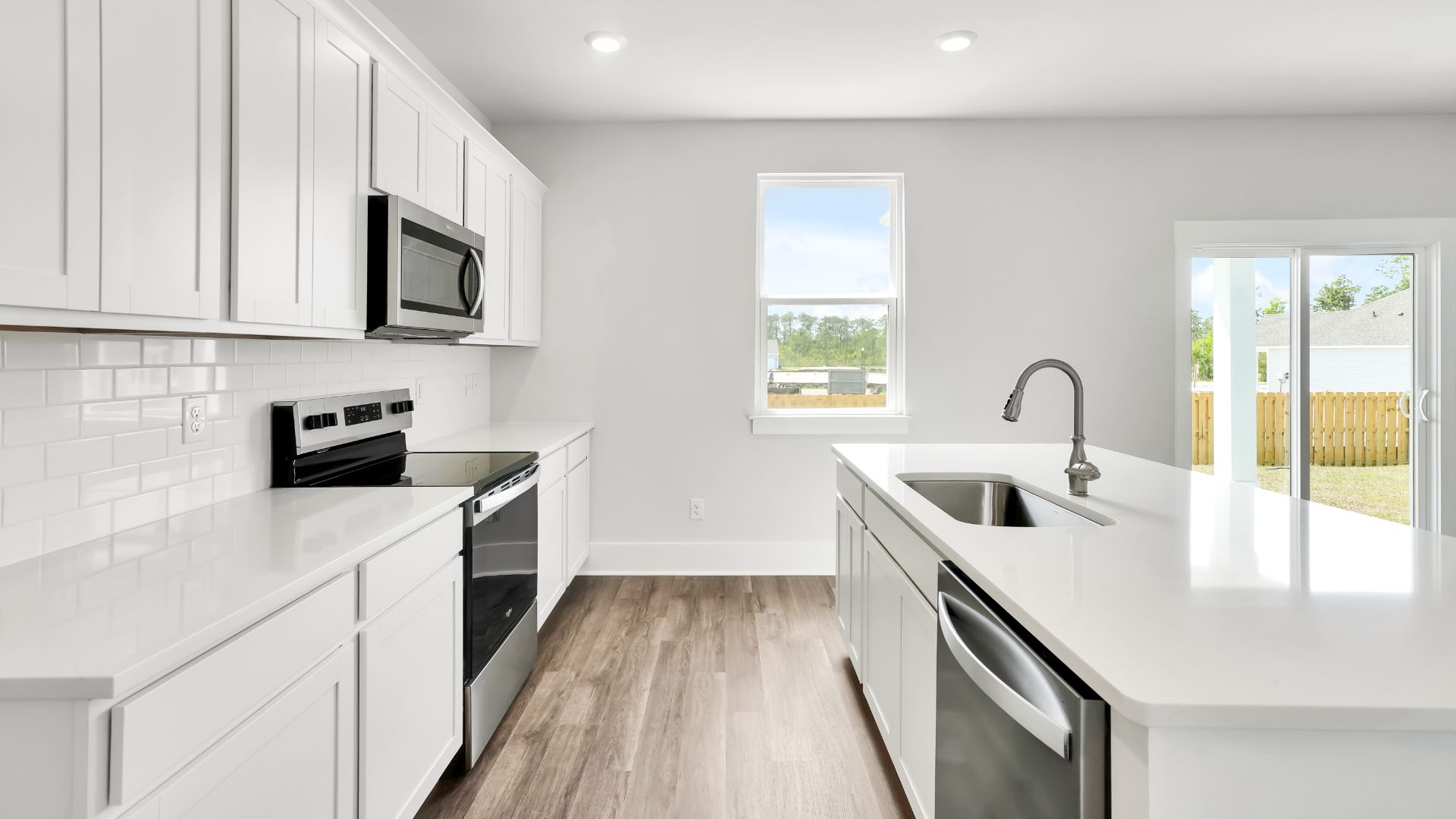 The kitchen features a large island and stainless-steel appliances, which are sure to both turn heads and make meal prep easy. You’ll never be too far from the action with the living and dining area right there.
