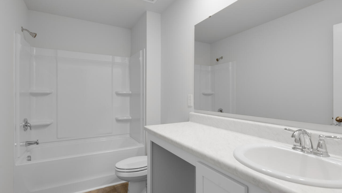 Upstairs, the Primary Suite offers a private bathroom, and the rest of the second floor includes three additional bedrooms and a convenient laundry room.