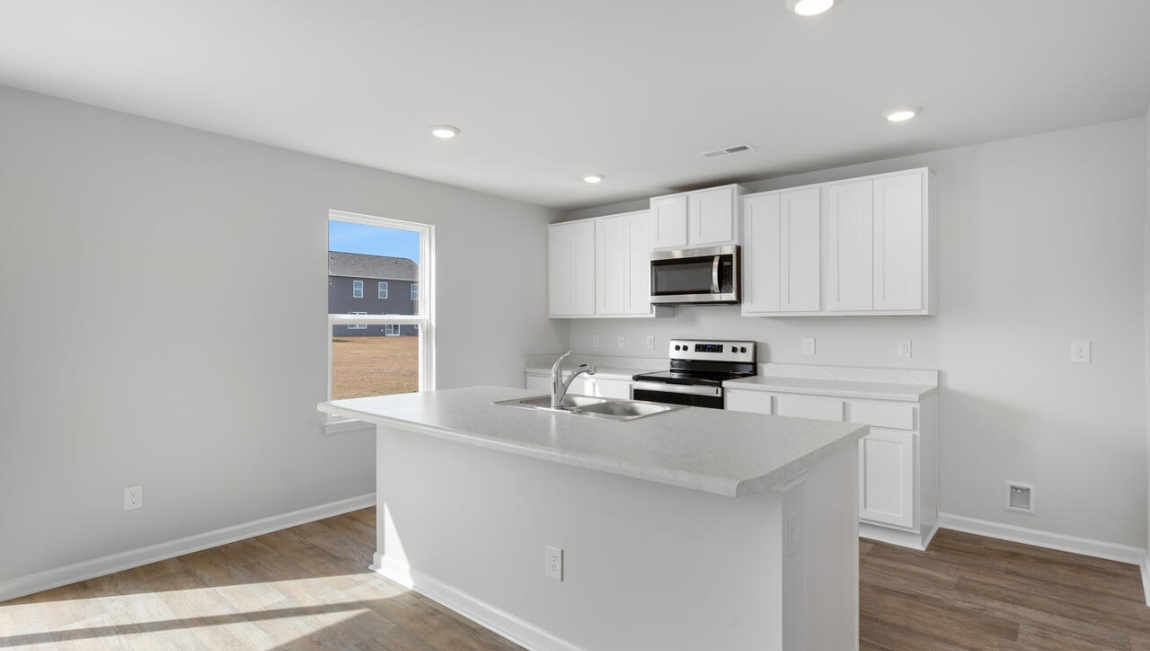 The kitchen features a large island and stainless steel appliances, which are sure to both turn heads and make meal prep easy. You’ll never be too far from the action with the living and dining area right there.