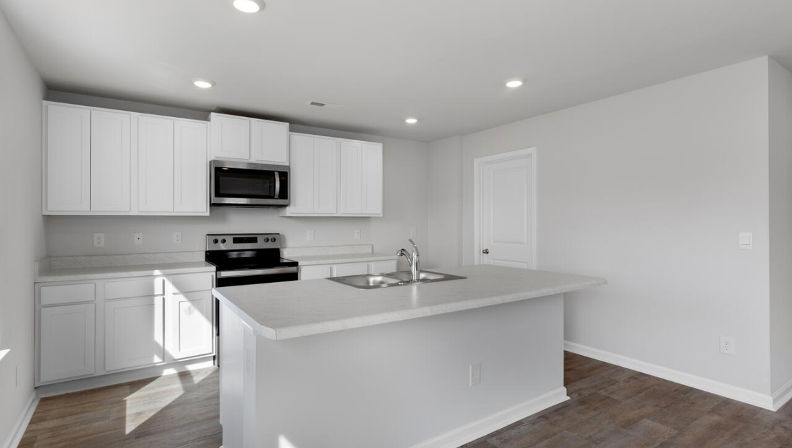 The kitchen features a large island and stainless steel appliances, which are sure to both turn heads and make meal prep easy. You’ll never be too far from the action with the living and dining area right there.