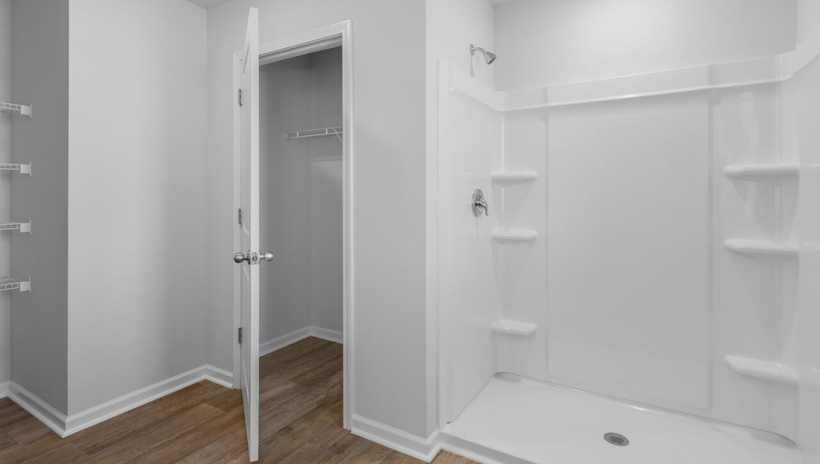 Upstairs, the Primary Suite offers a private bathroom, and the rest of the second floor includes three additional bedrooms and a convenient laundry room.
