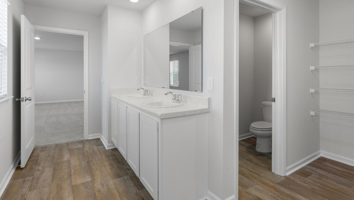 Upstairs, the Primary Suite offers a private bathroom, and the rest of the second floor includes three additional bedrooms and a convenient laundry room.