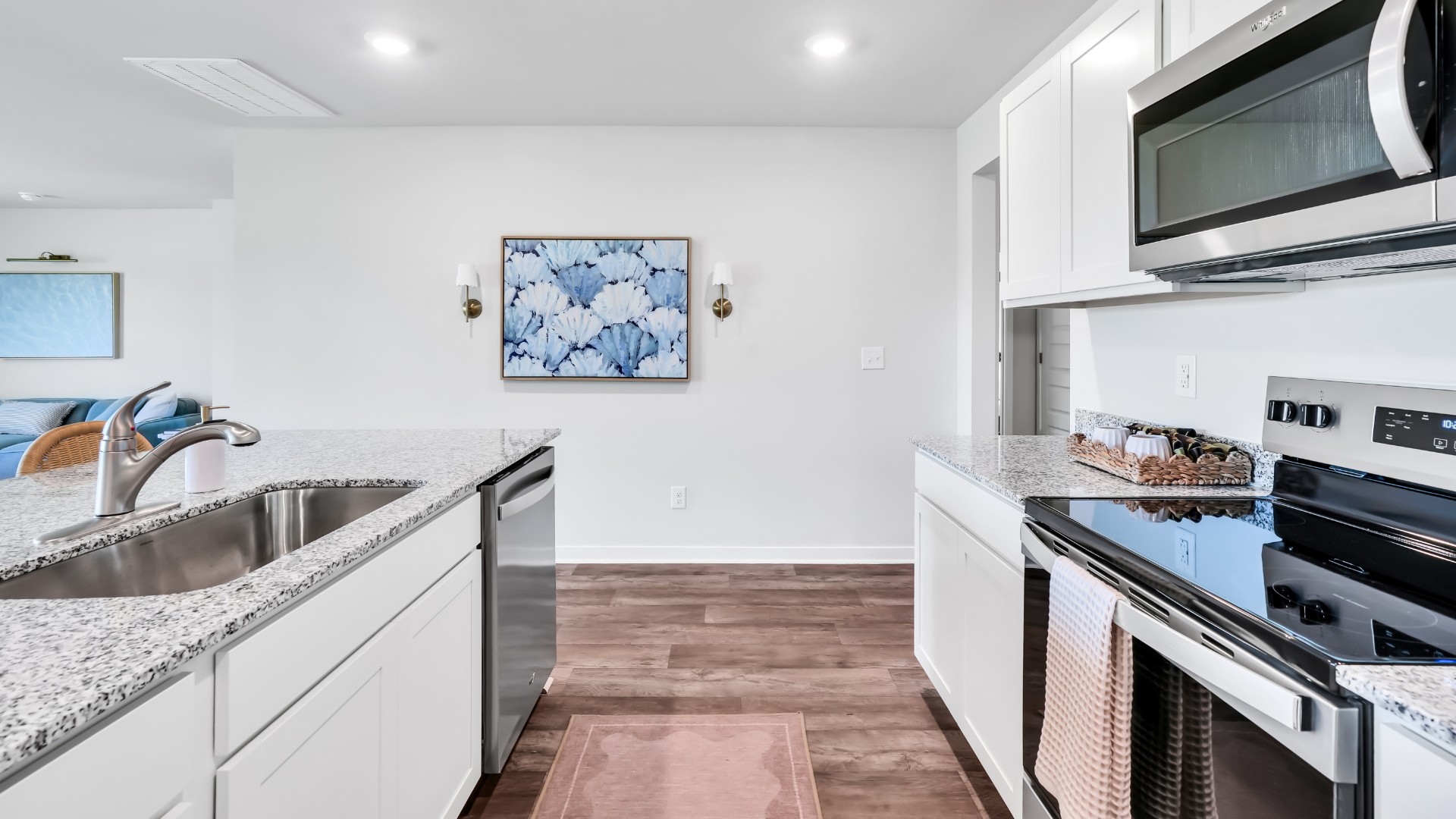The kitchen features a large island, laminate countertops, and stainless steel appliances, which are sure to both turn heads and make meal prep easy. You’ll never be too far from the action with the living and dining area right there.