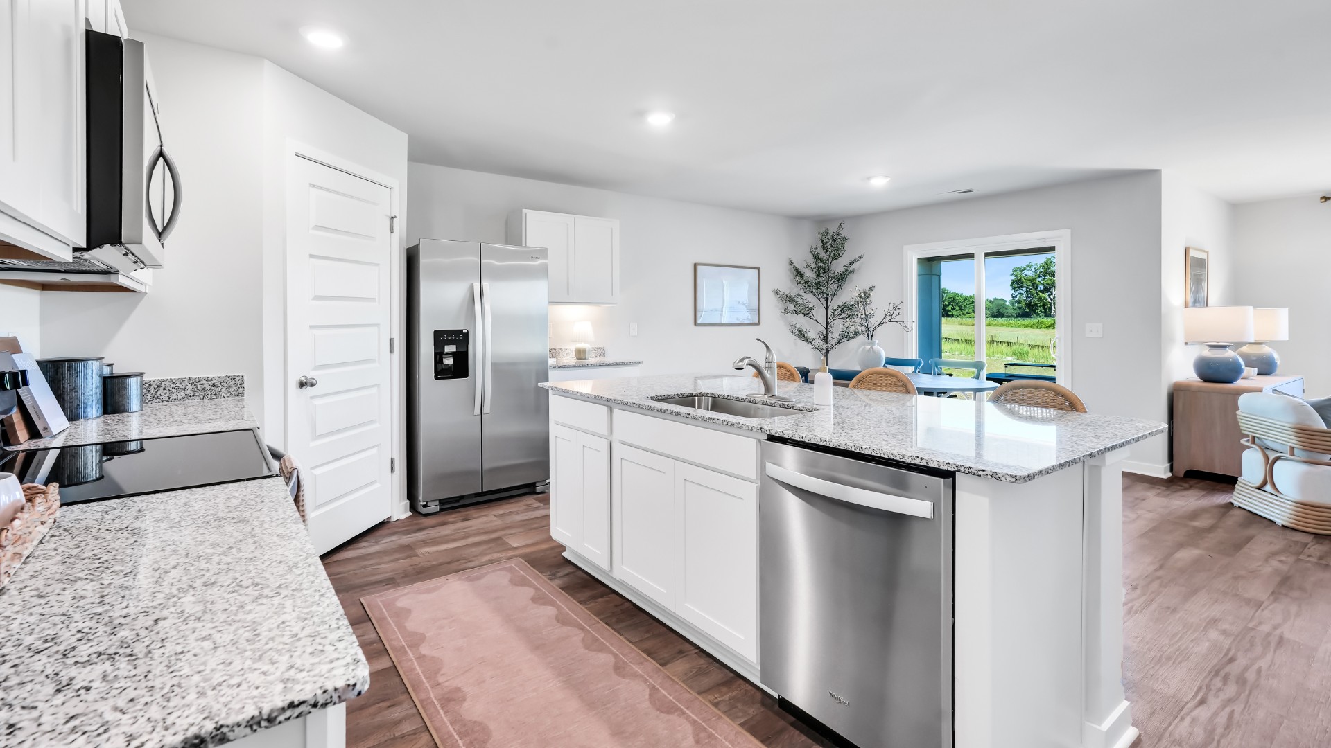 The kitchen is a showstopper with granite countertops, stainless steel appliances, and a big island perfect for entertaining or casual meals. You’ll never be too far from the action with the living and dining area right there.