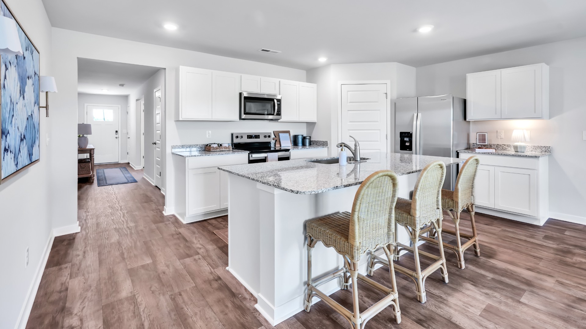 The kitchen is a showstopper with granite countertops, stainless steel appliances, and a big island perfect for entertaining or casual meals. You’ll never be too far from the action with the living and dining area right there.