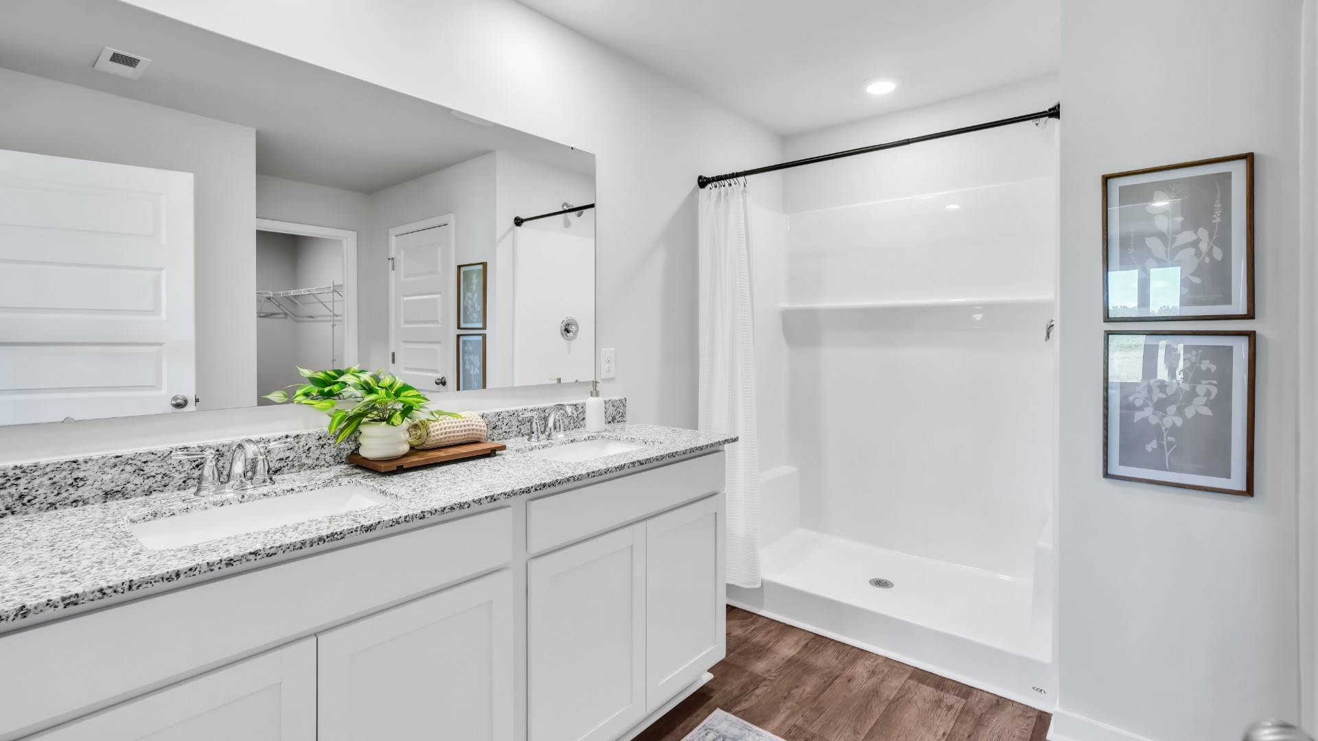 Need privacy? The primary suite is tucked away in the back of the home, offering a peaceful retreat complete with a walk-in shower (glass door included!), granite vanity, and a roomy walk-in closet.