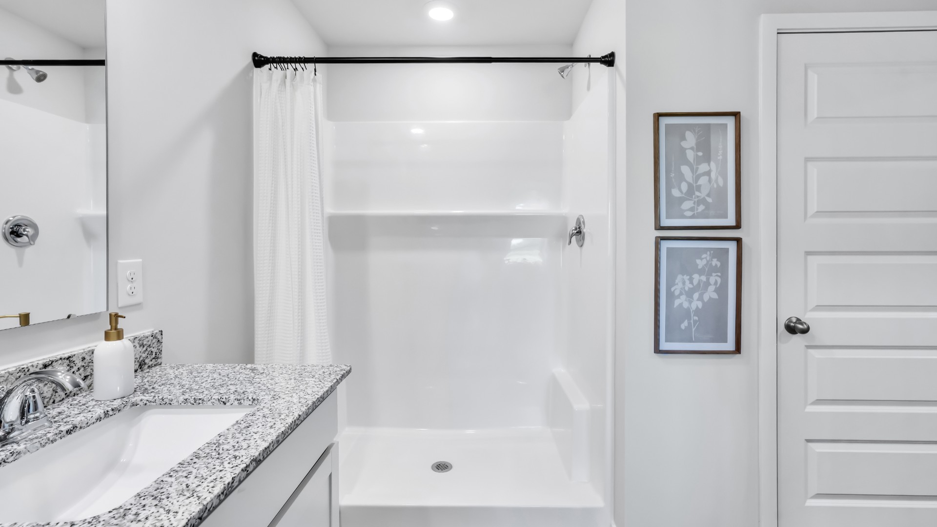 Need privacy? The primary suite is tucked away in the back of the home, offering a peaceful retreat complete with a walk-in shower (glass door included!), granite vanity, and a roomy walk-in closet.