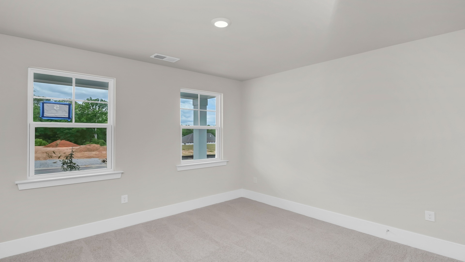 The front bedroom/bedroom 2 features 2 windows and carpet flooring.