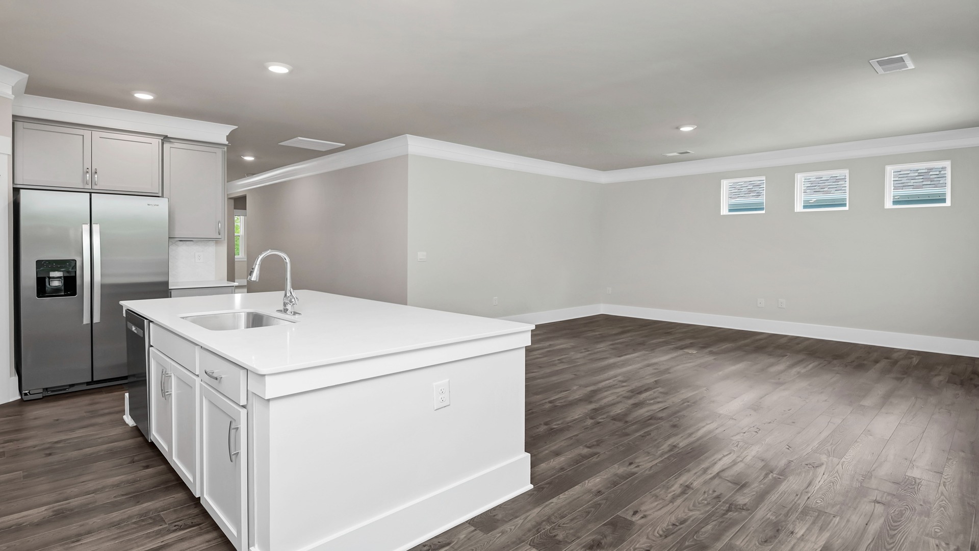 The floating kitchen island overlooks the dining and living areas.