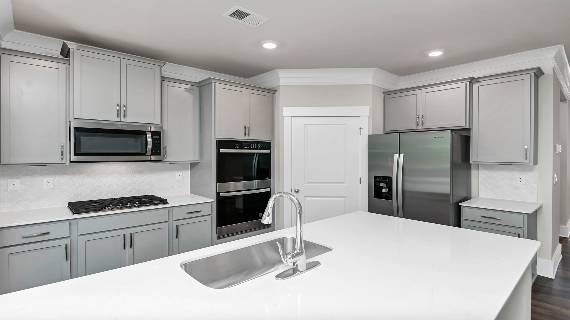 This Bradford kitchen features white cabinetry, even though gray cabinetry is pictured.