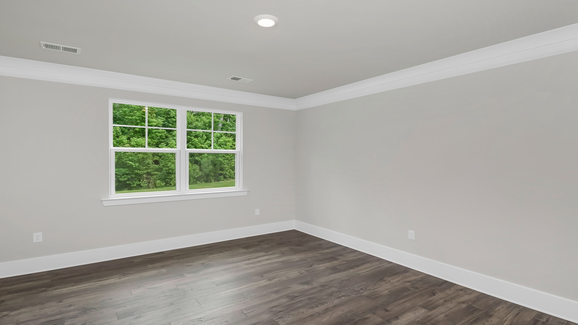 The primary bedroom features matching luxury vinyl flooring and a large window.