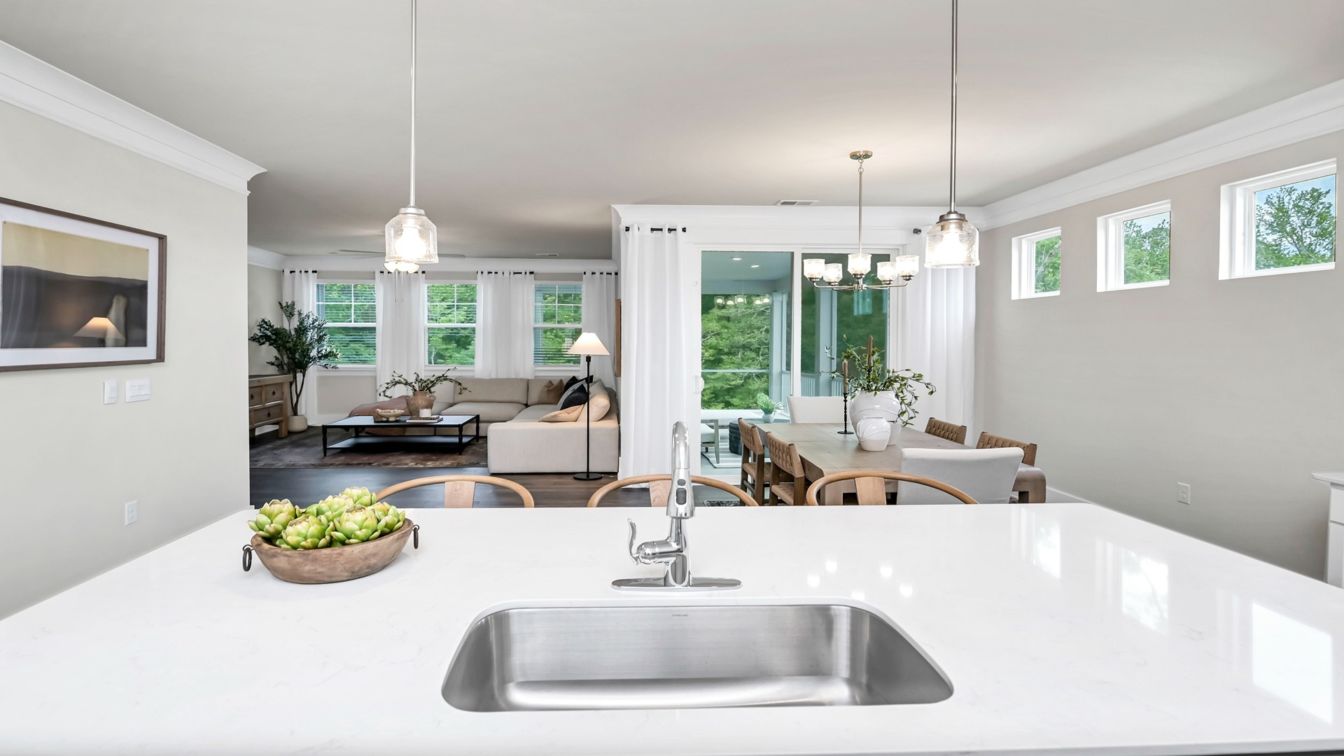 The kitchen sink overlooks the dining and living areas.