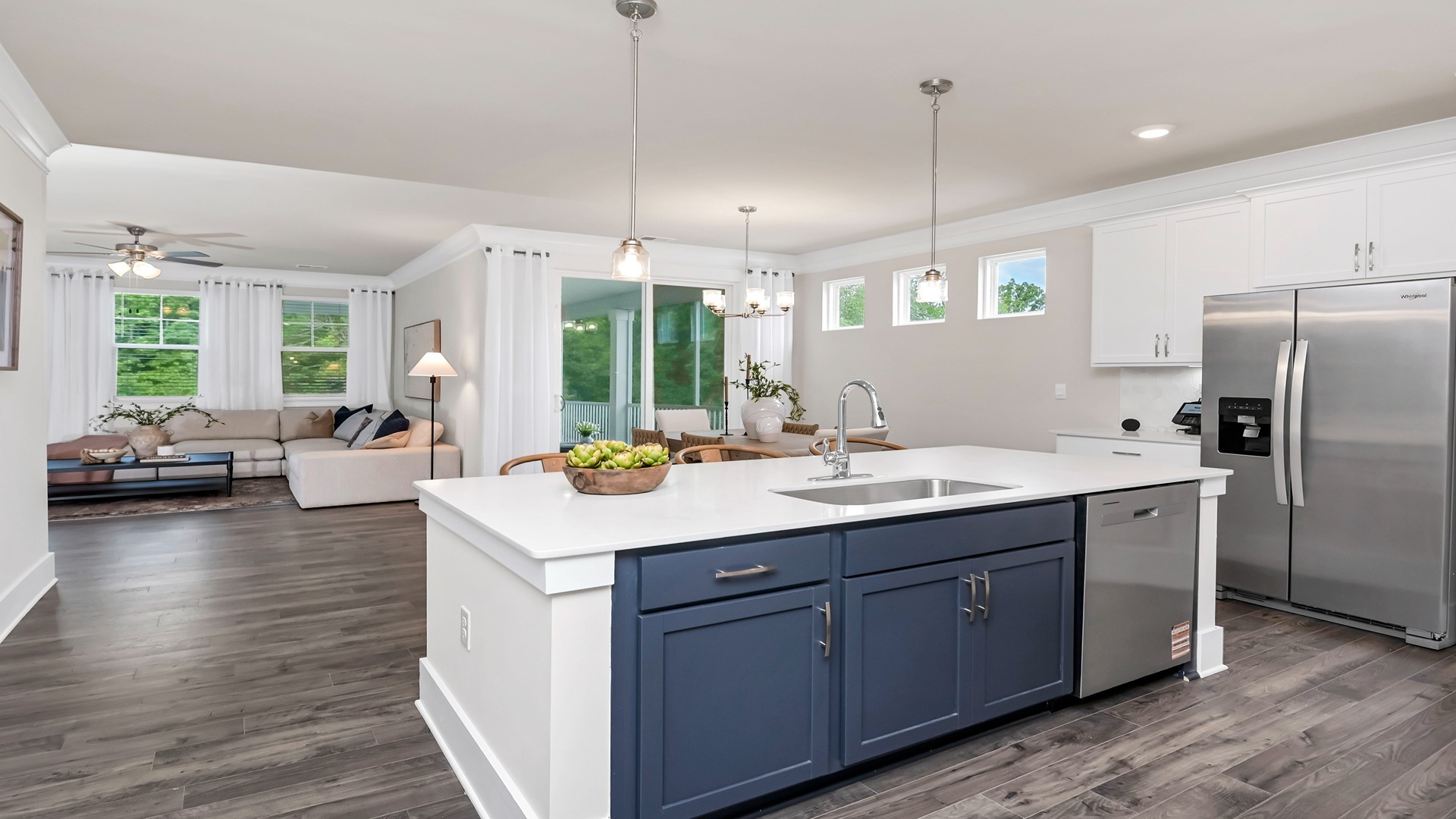 Floating kitchen island overlooks dining and living areas