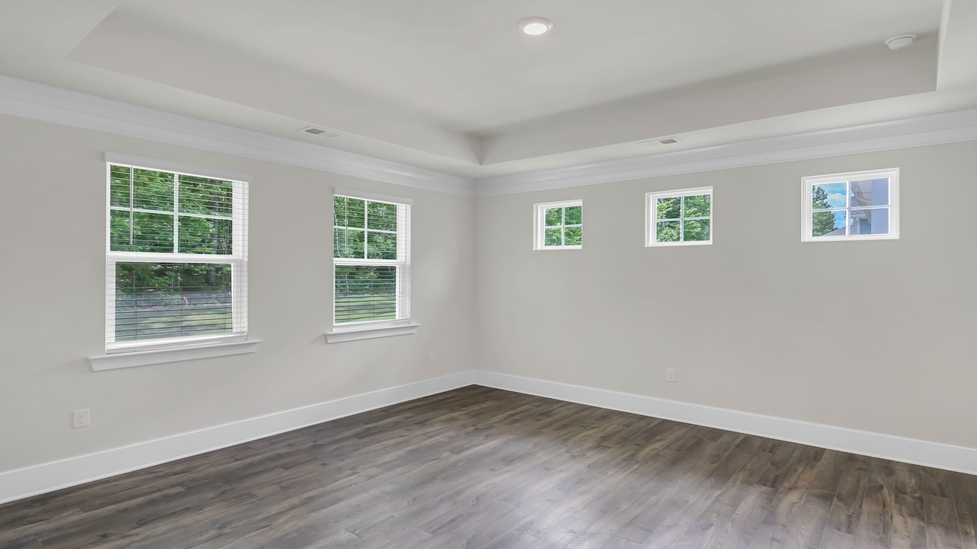 Primary bedroom privately at back of home
