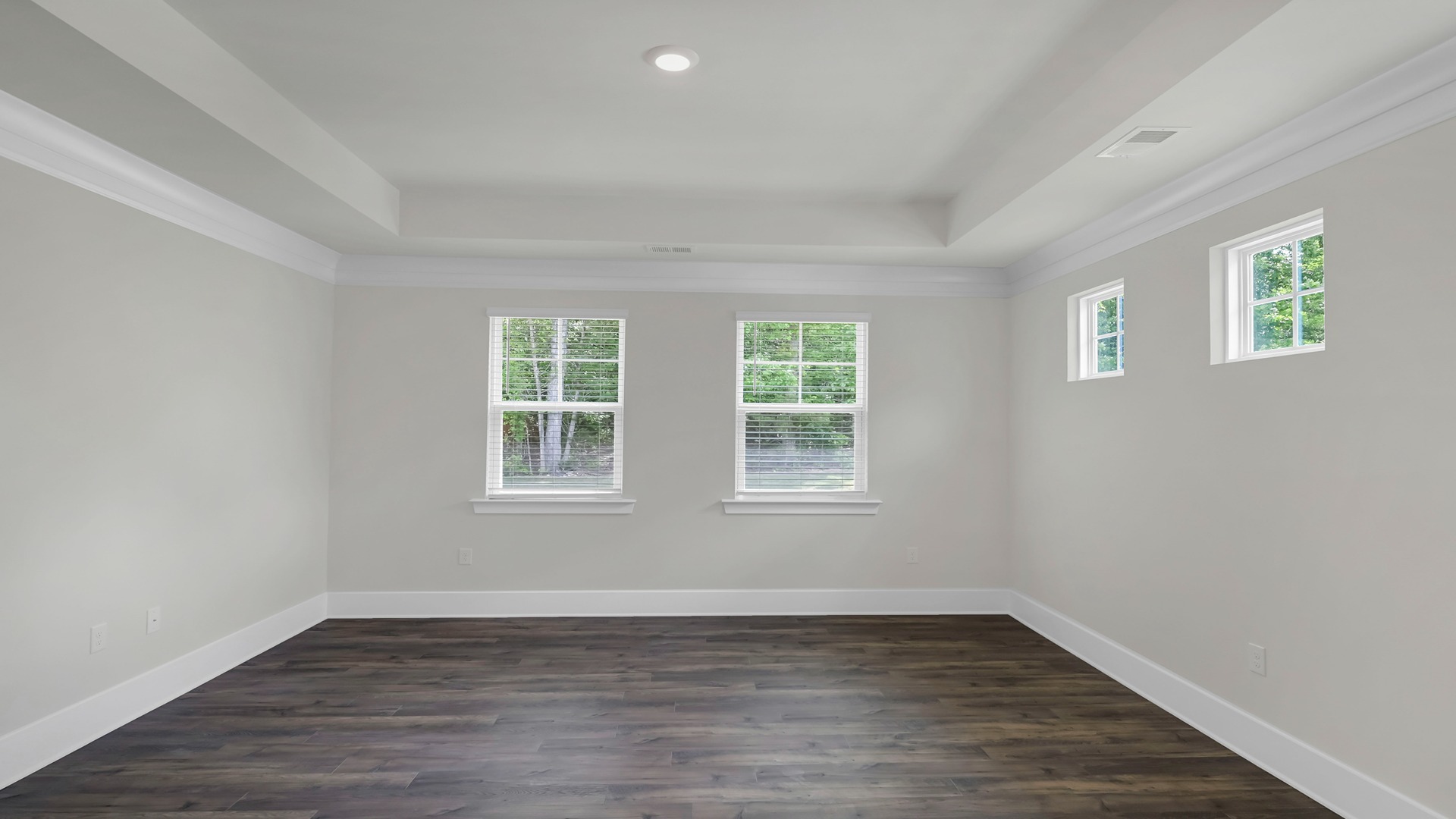 Revwood flooring and several windows in primary bedroom